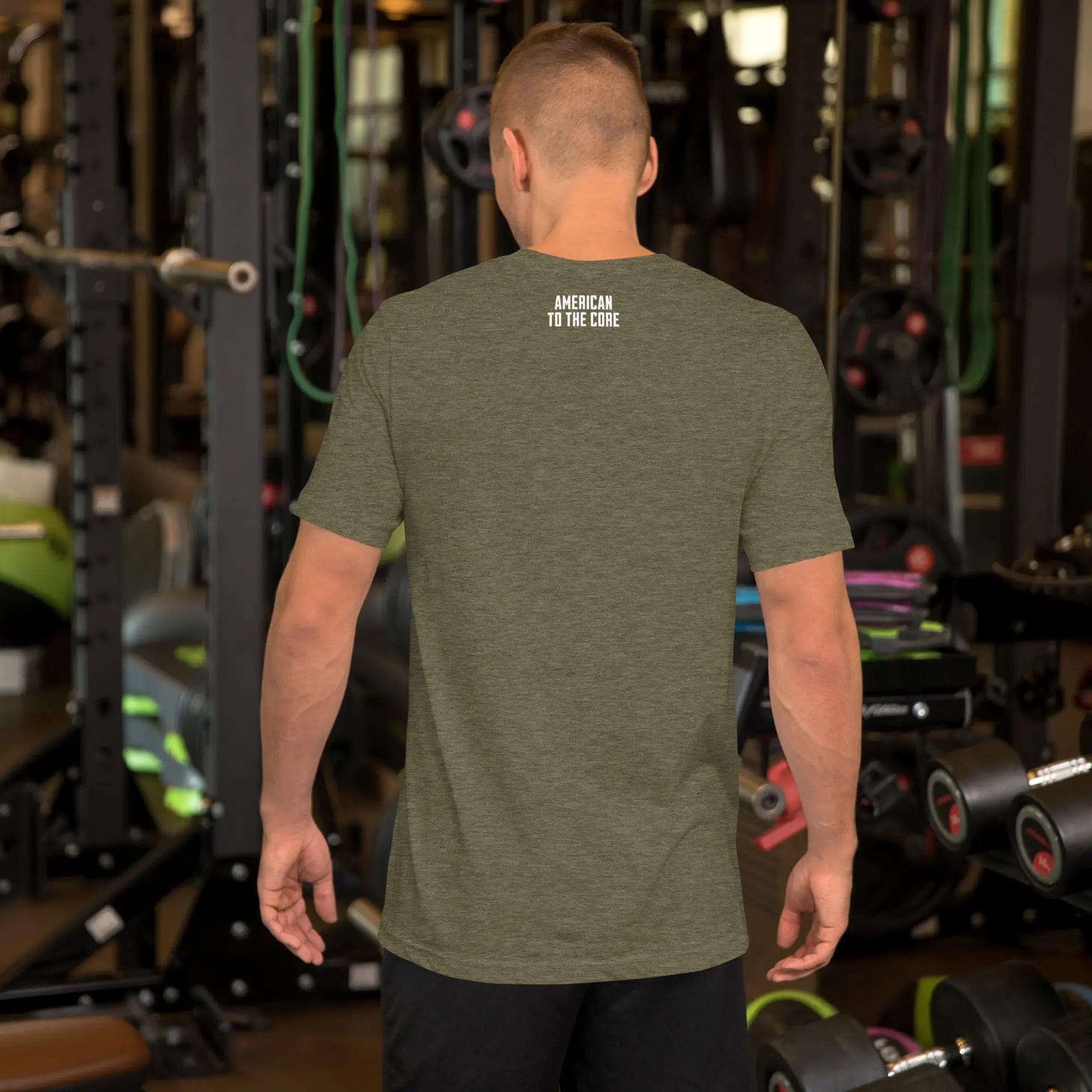 Back of a man wearing a heather olive patriotic t-shirt with the text "American To The Core."