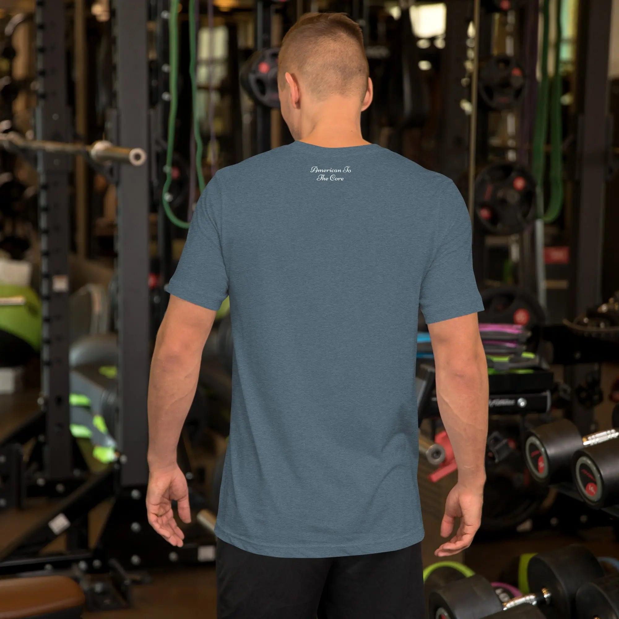 Back of a man wearing a heather slate blue patriotic t-shirt with the text "American To The Core."