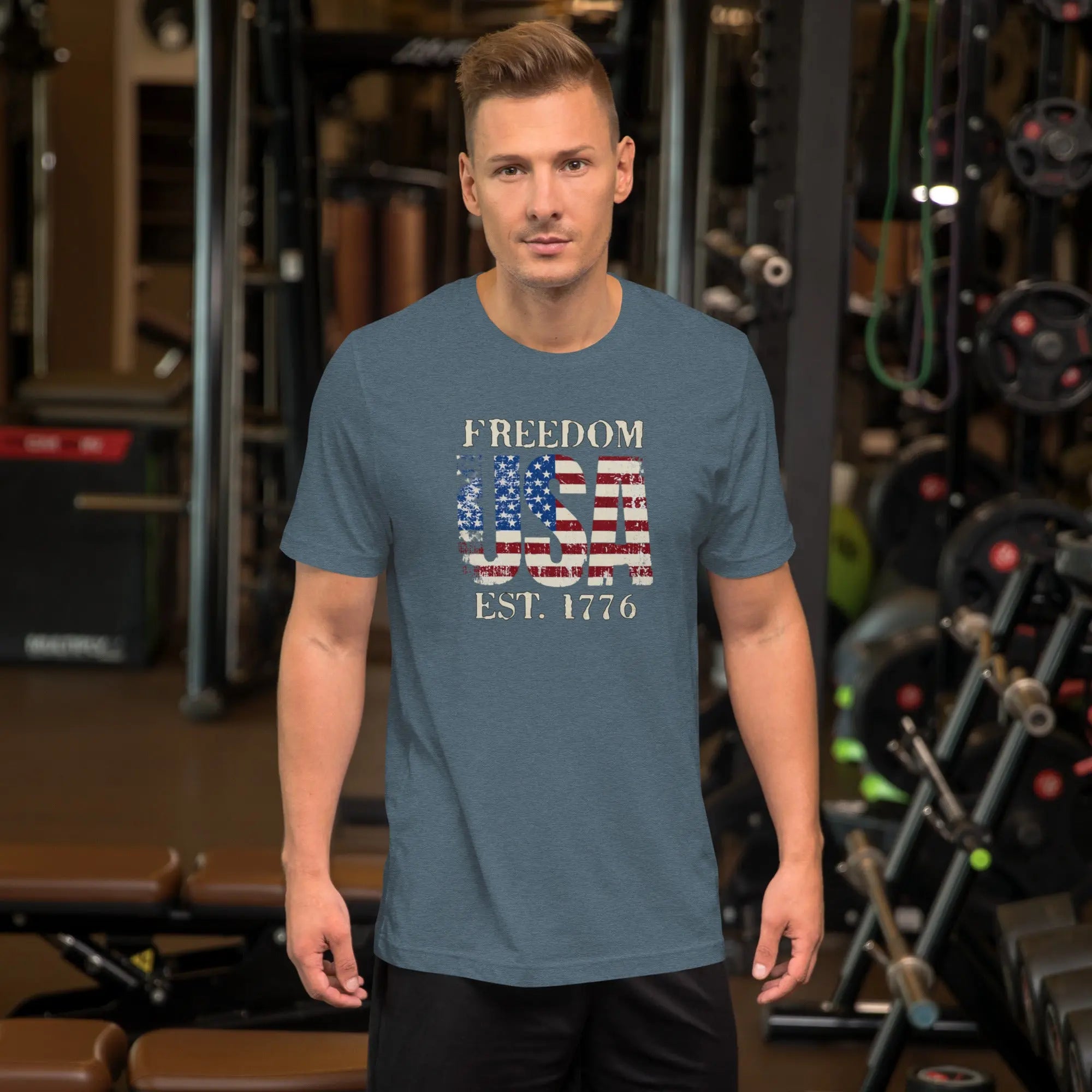 a man wearing a heather blue patriotic t-shirt with "Freedom USA Est. 1776" text.
