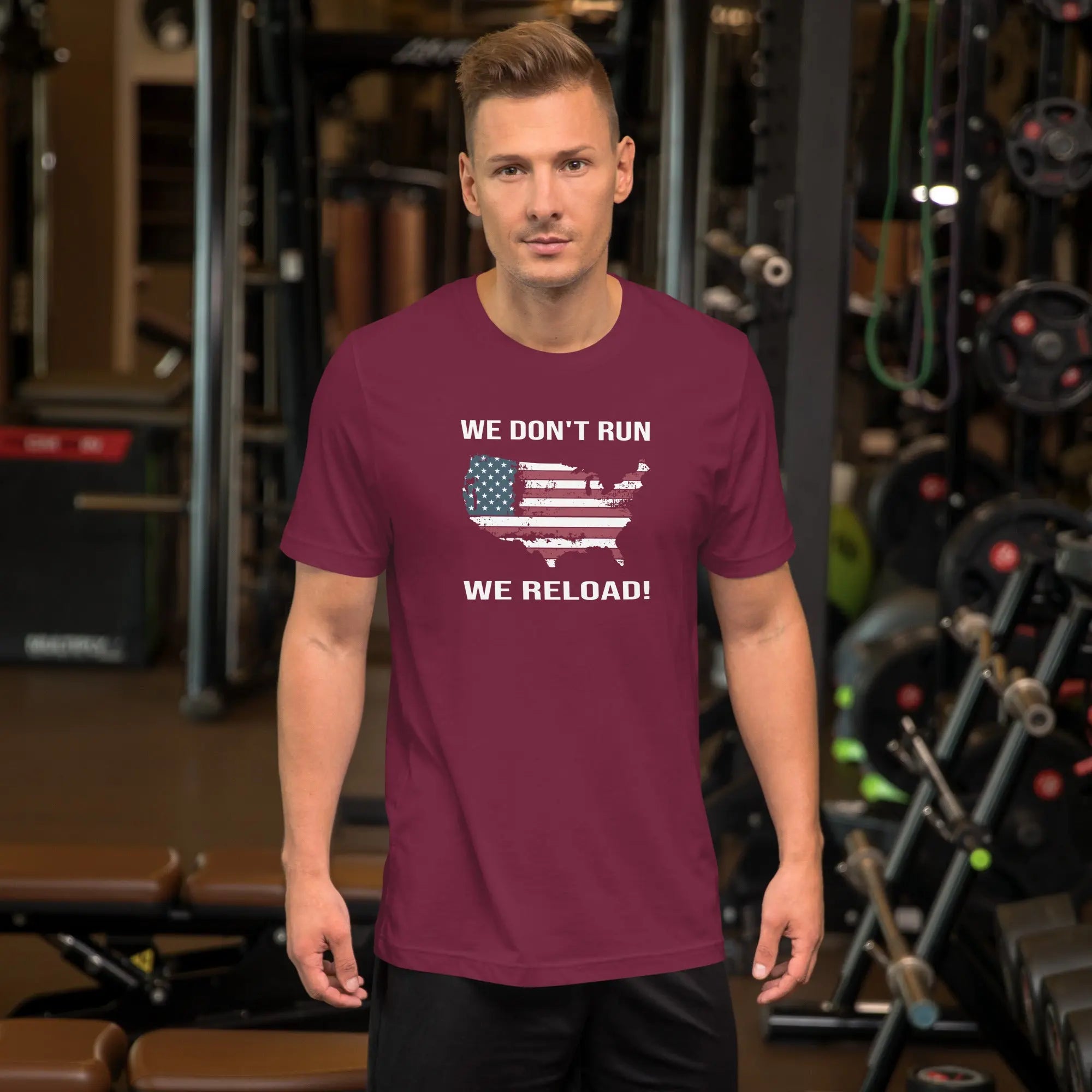 man wearing a maroon patriotic t-shirt with "We don't run, we reload" text.