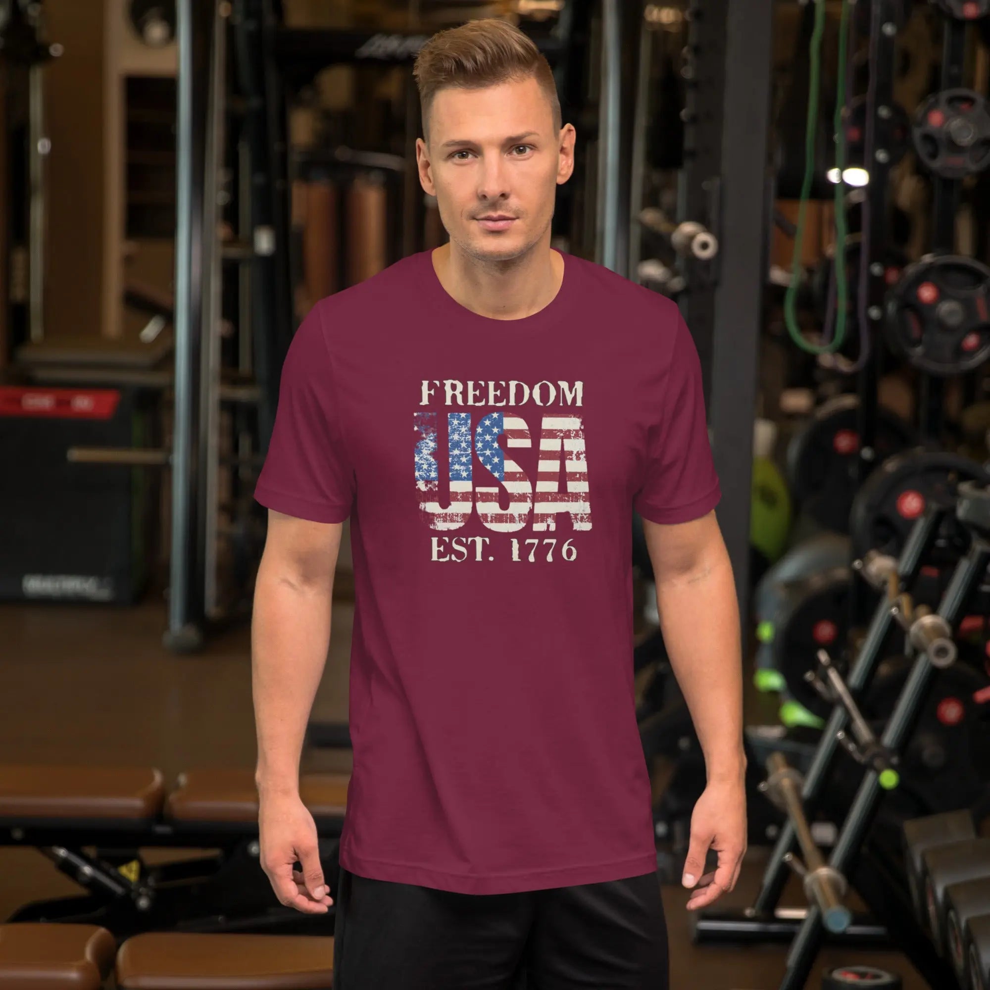 a man wearing a maroon patriotic t-shirt with "Freedom USA Est. 1776" text.