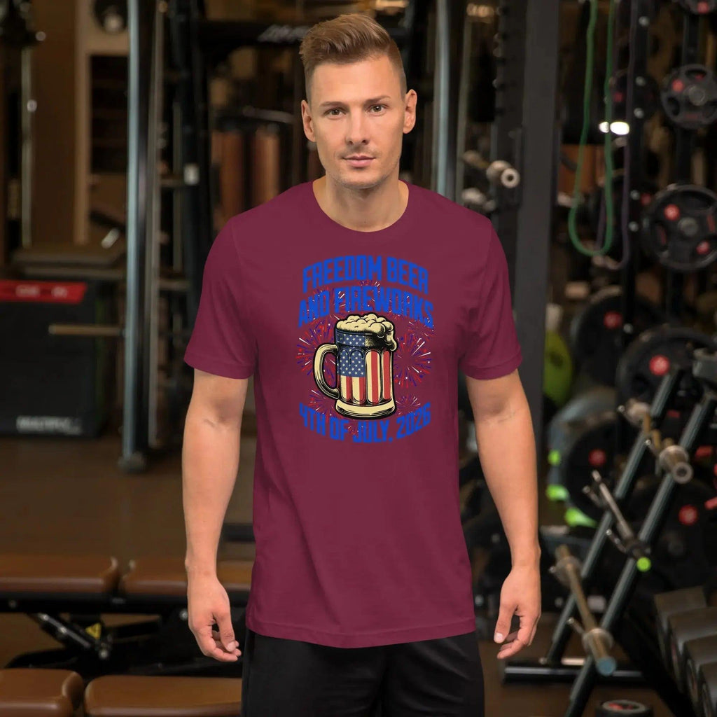 A man wearing a maroon patriotic t-shirt with a beer mug and fireworks with the text "Freedom, Beer, and Fireworks" and "4th of july, 2026."