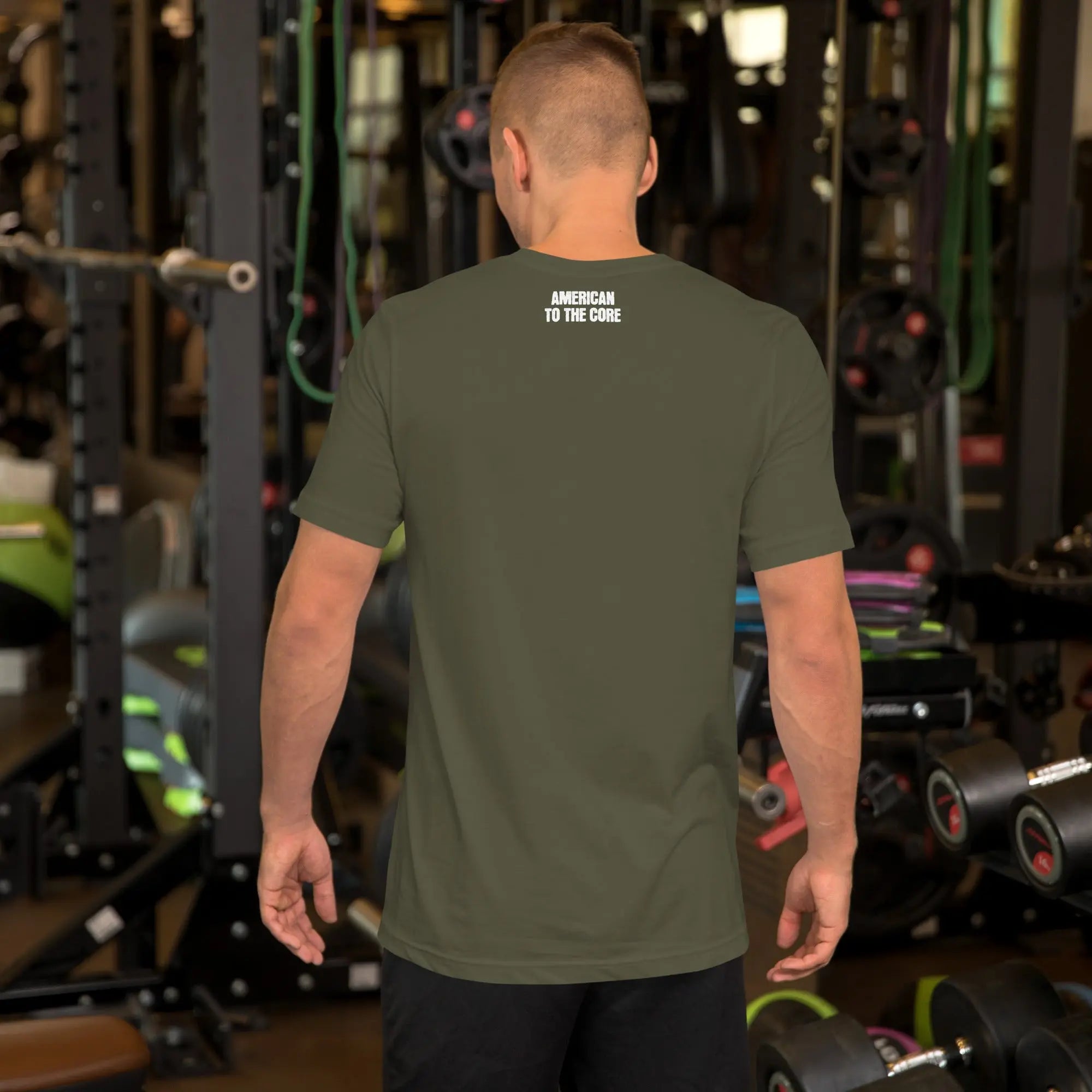Back of man wearing a military green patriotic t-shirt with "America to the core" text
