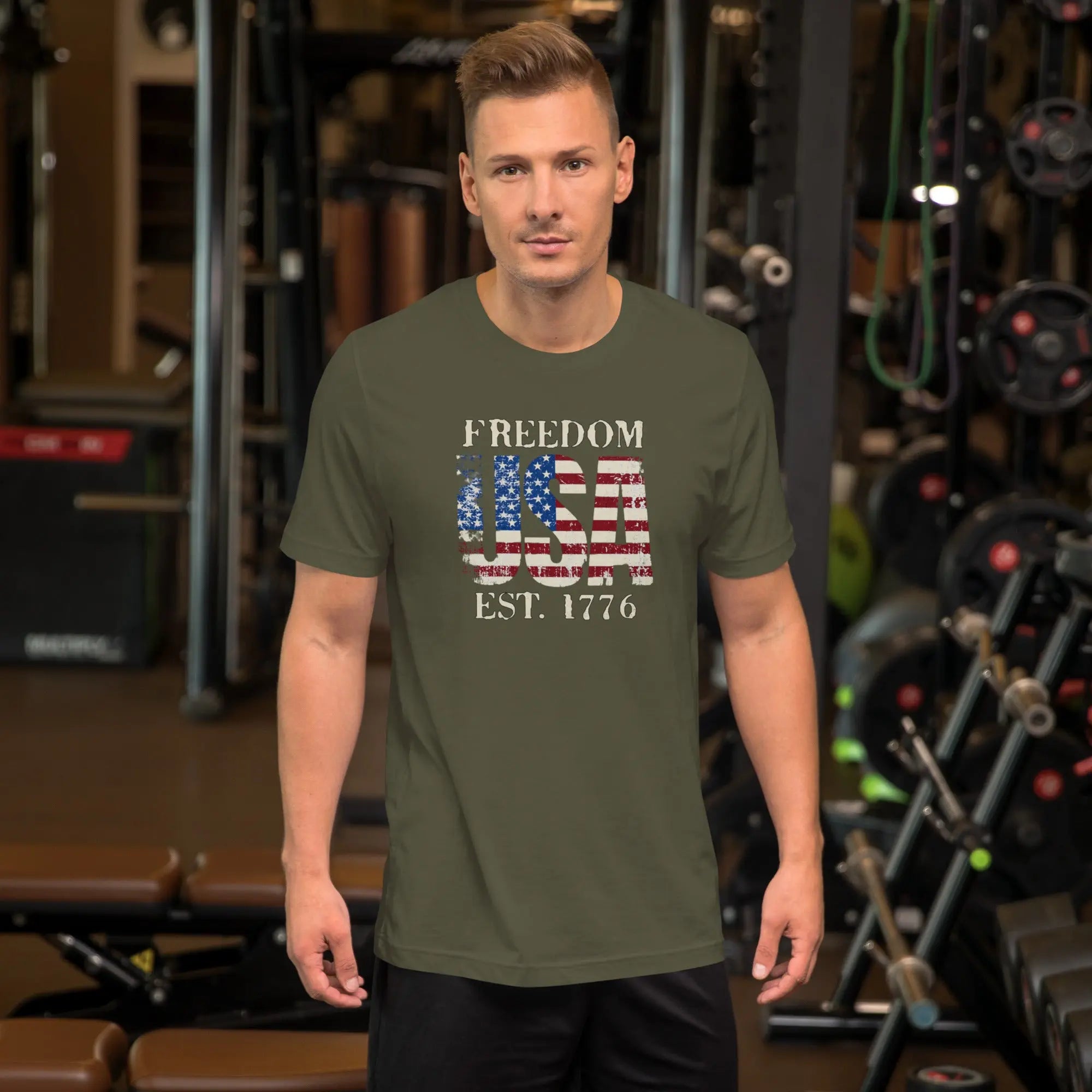 a man wearing a green military patriotic t-shirt with "Freedom USA Est. 1776" text.