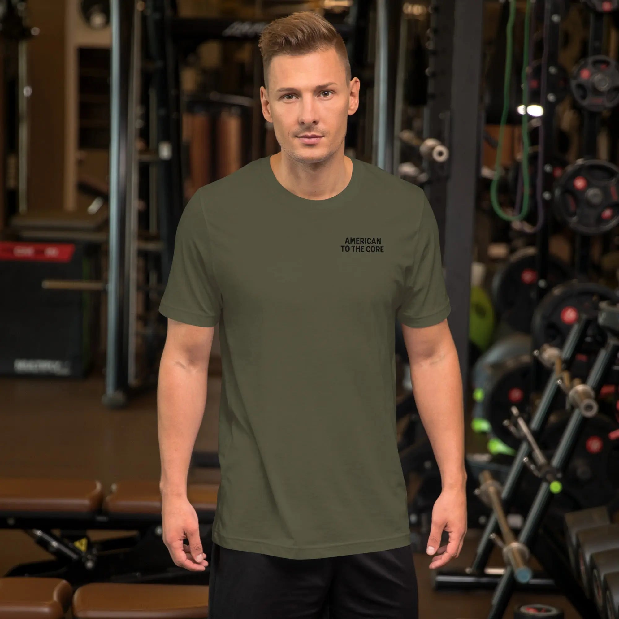 Front of man wearing a military green patriotic t-shirt with "American To The Core" text.