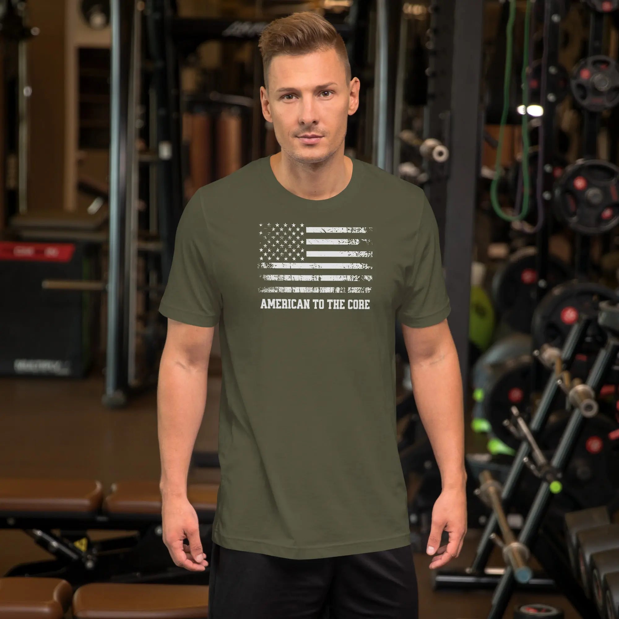 A man wearing a military green patriotic t-shirt with an American flag and "American to the core" text.