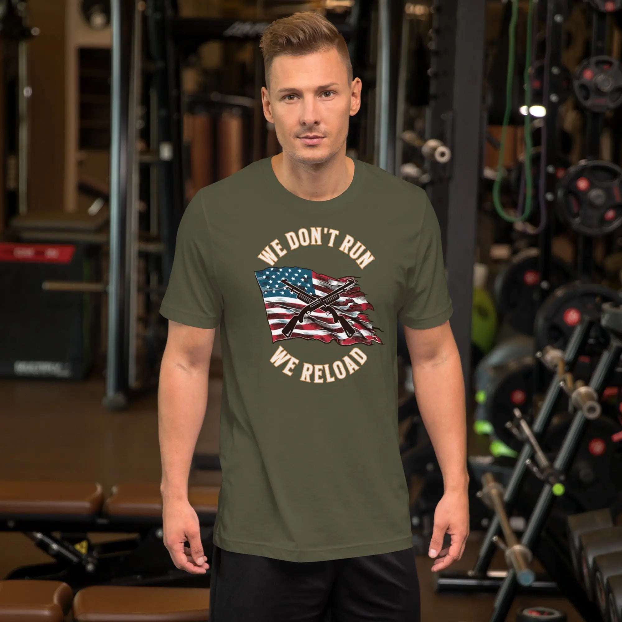 A man wearing a military green patriotic t-shirt with shotguns over the American flag and the "We don't run, we reload" text.