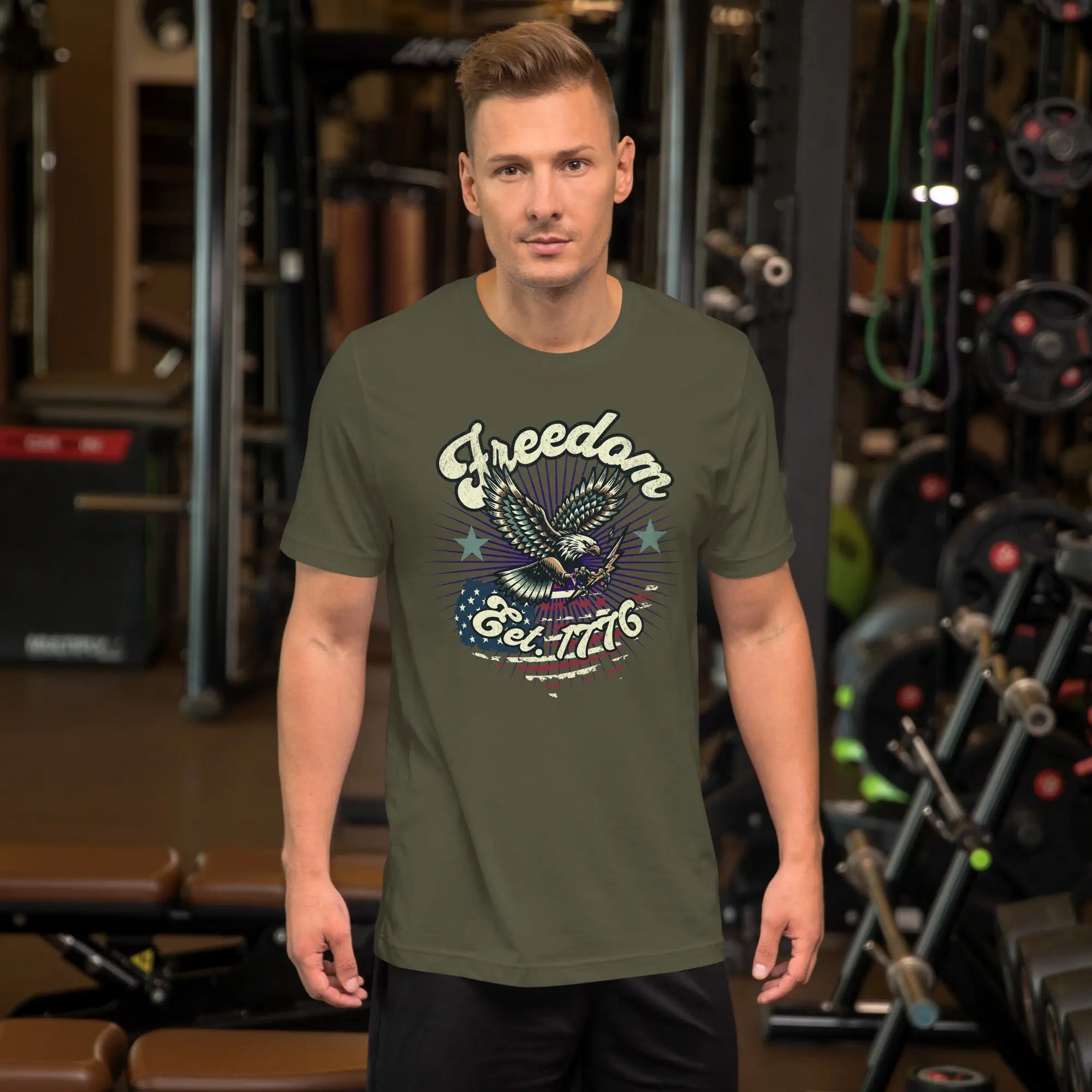A man wearing a military green patriotic t-shirt with an eagle and "Freedom Est. 1776" text.