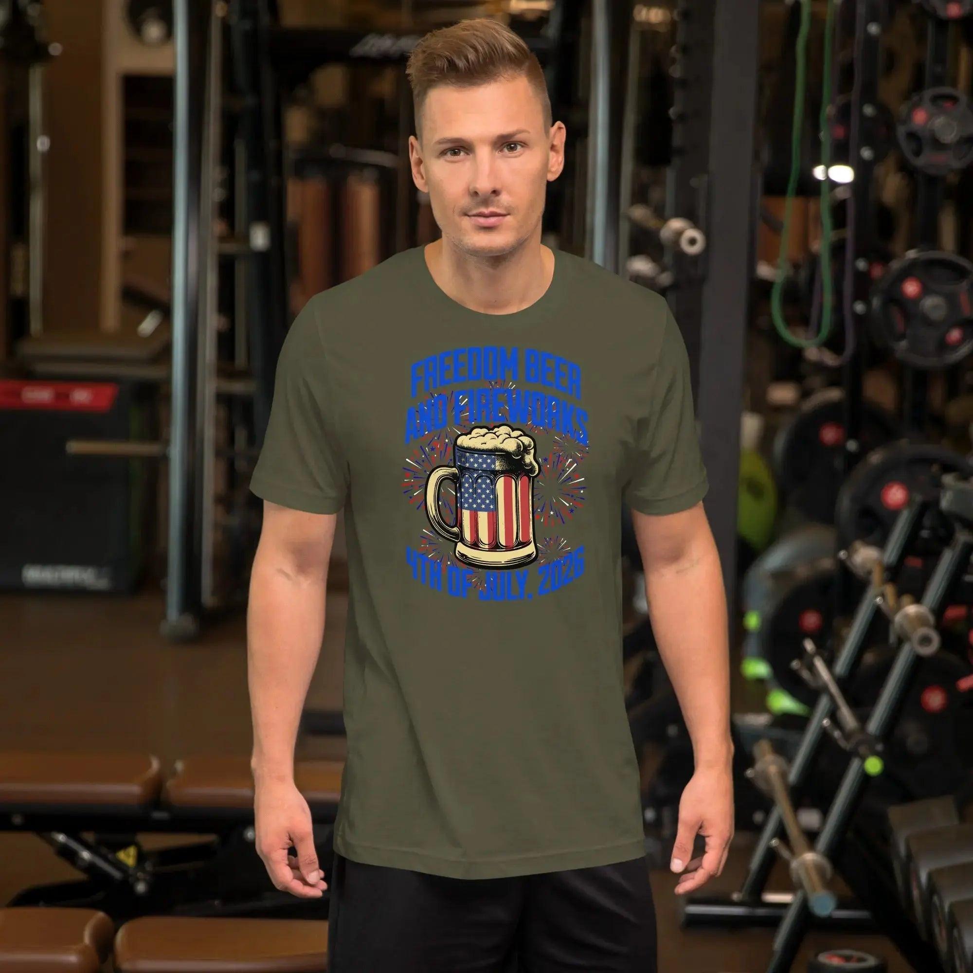 A man wearing a military green patriotic t-shirt with a beer mug and fireworks with the text "Freedom, Beer, and Fireworks" and "4th of July, 2026."