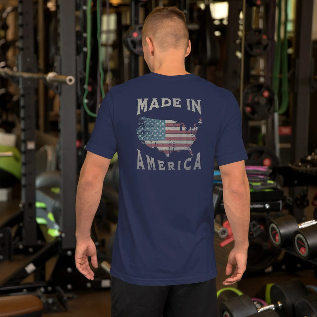 man wearing a navy blue patriotic t-shirt with "made in america" text. A silhouette of america with the american flag in it. 