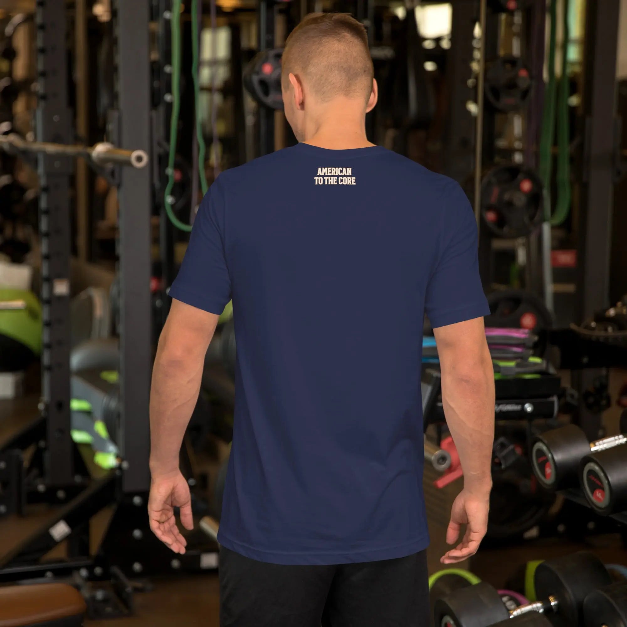Back of man wearing a navy patriotic t-shirt with "America to the core" text