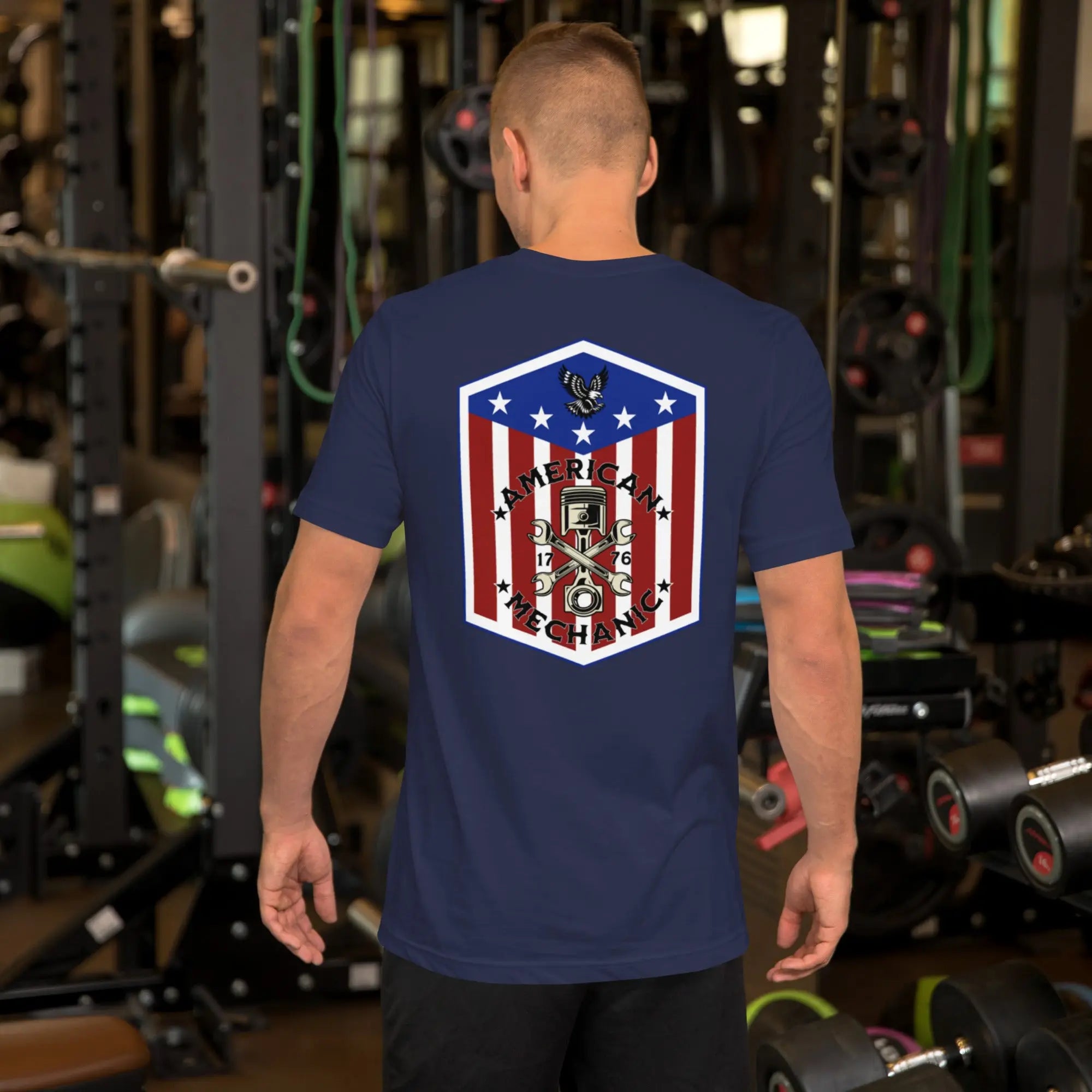 Back of man wearing a navy patriotic t-shirt with "American Mechanic" text