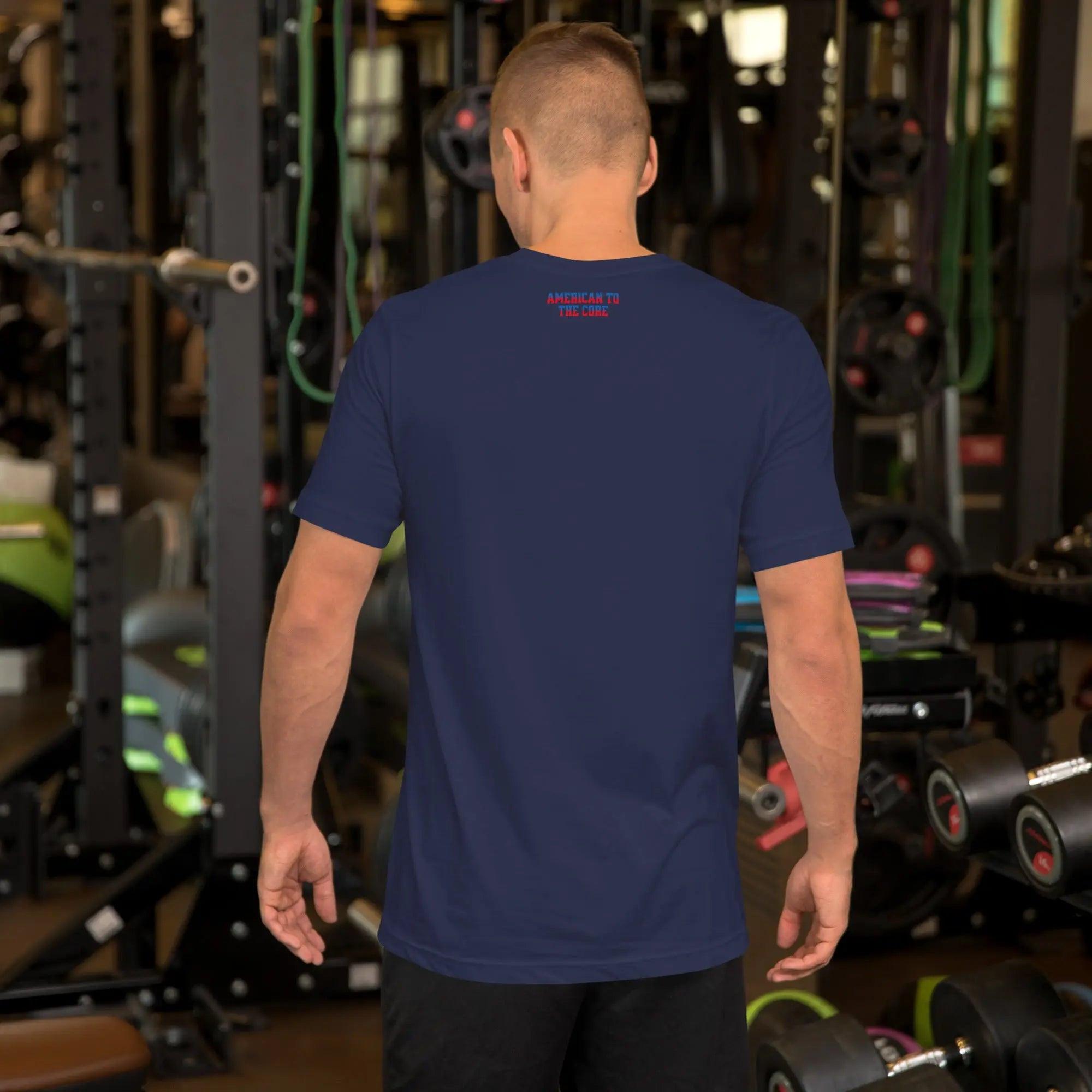 Back of a man wearing a navy-blue patriotic men's T-shirt with the text "American To The Core" in red and blue. 