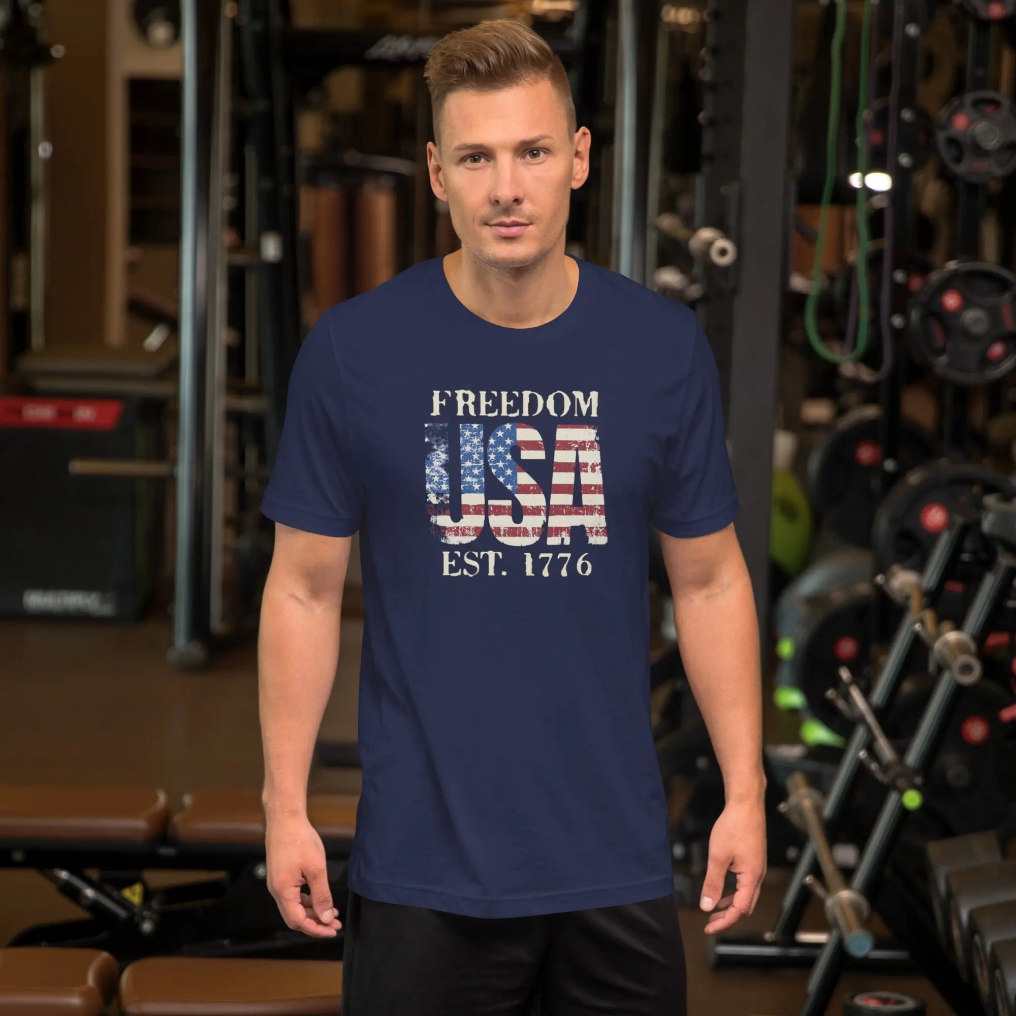 a man wearing a navy blue patriotic t-shirt with "Freedom USA Est. 1776" text.