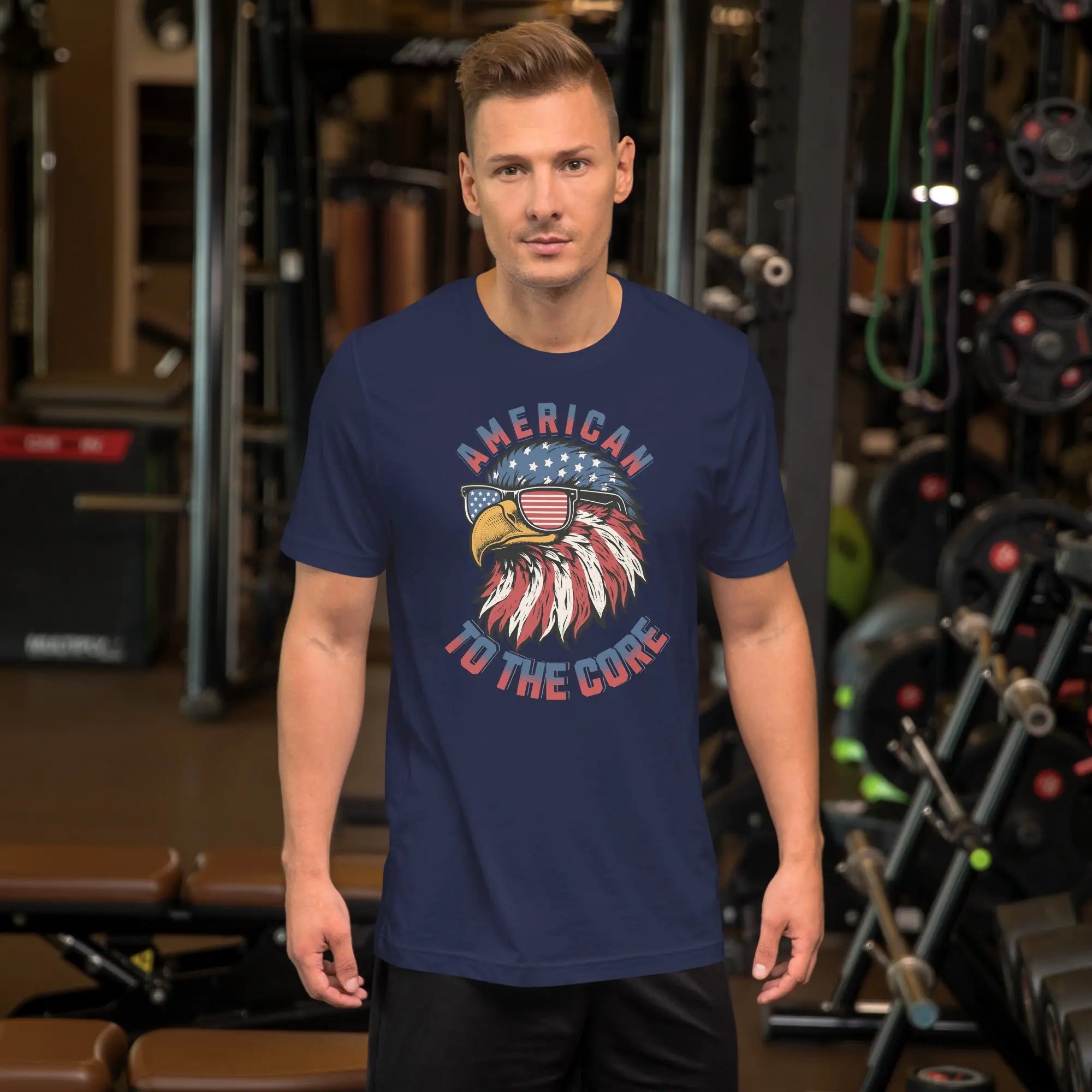 A man wearing a navy blue patriotic t-shirt with an eagle head with "American to the core" text.