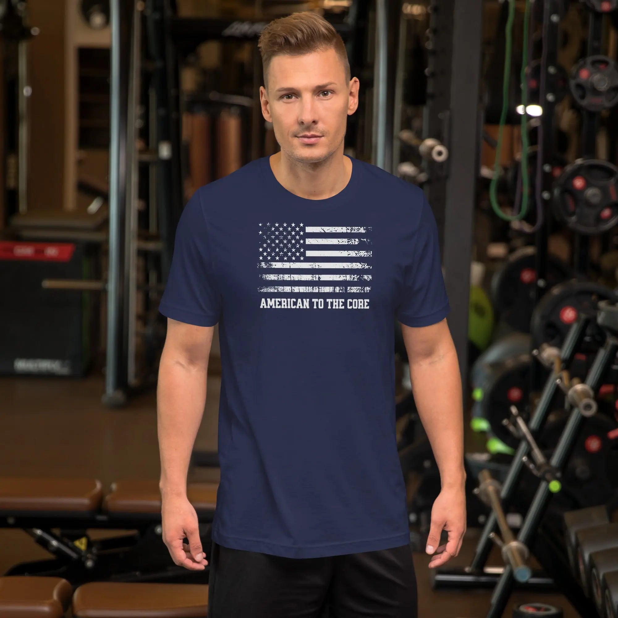A man wearing a navy patriotic t-shirt with an American flag and "American to the core" text.
