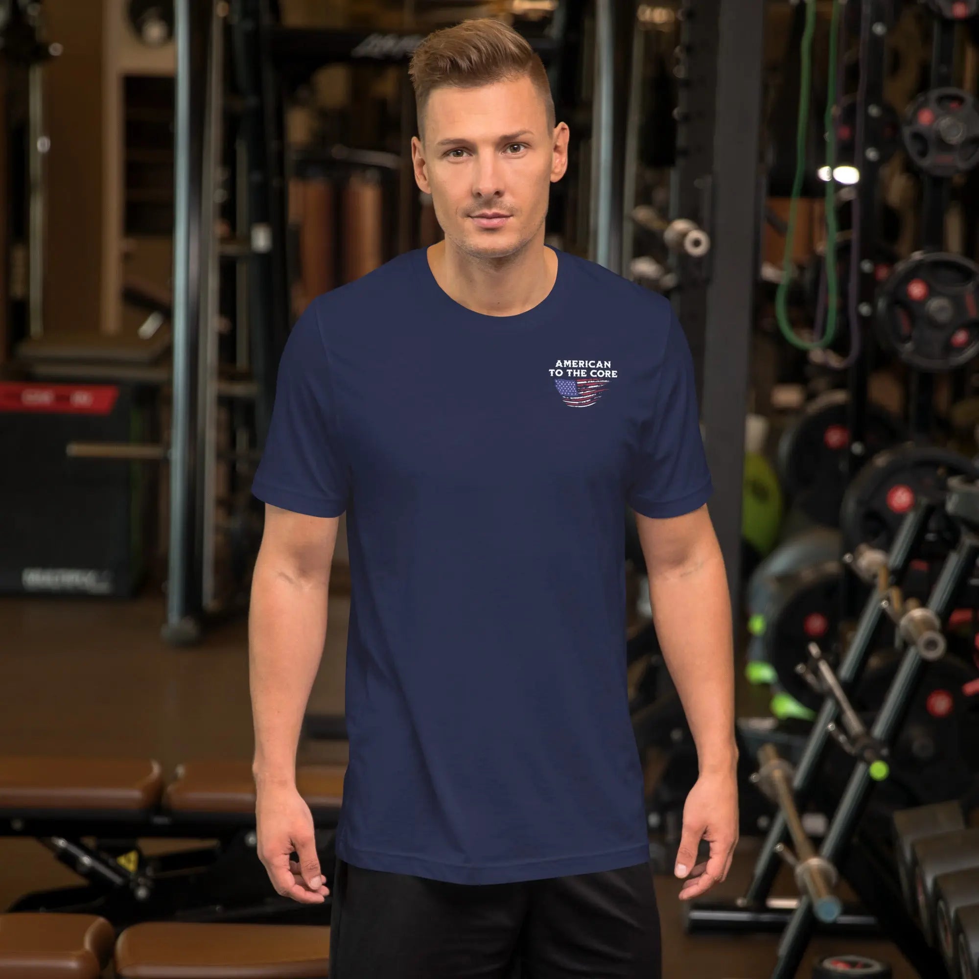 A man wearing a navy patriotic t-shirt with "American To The Core" text.