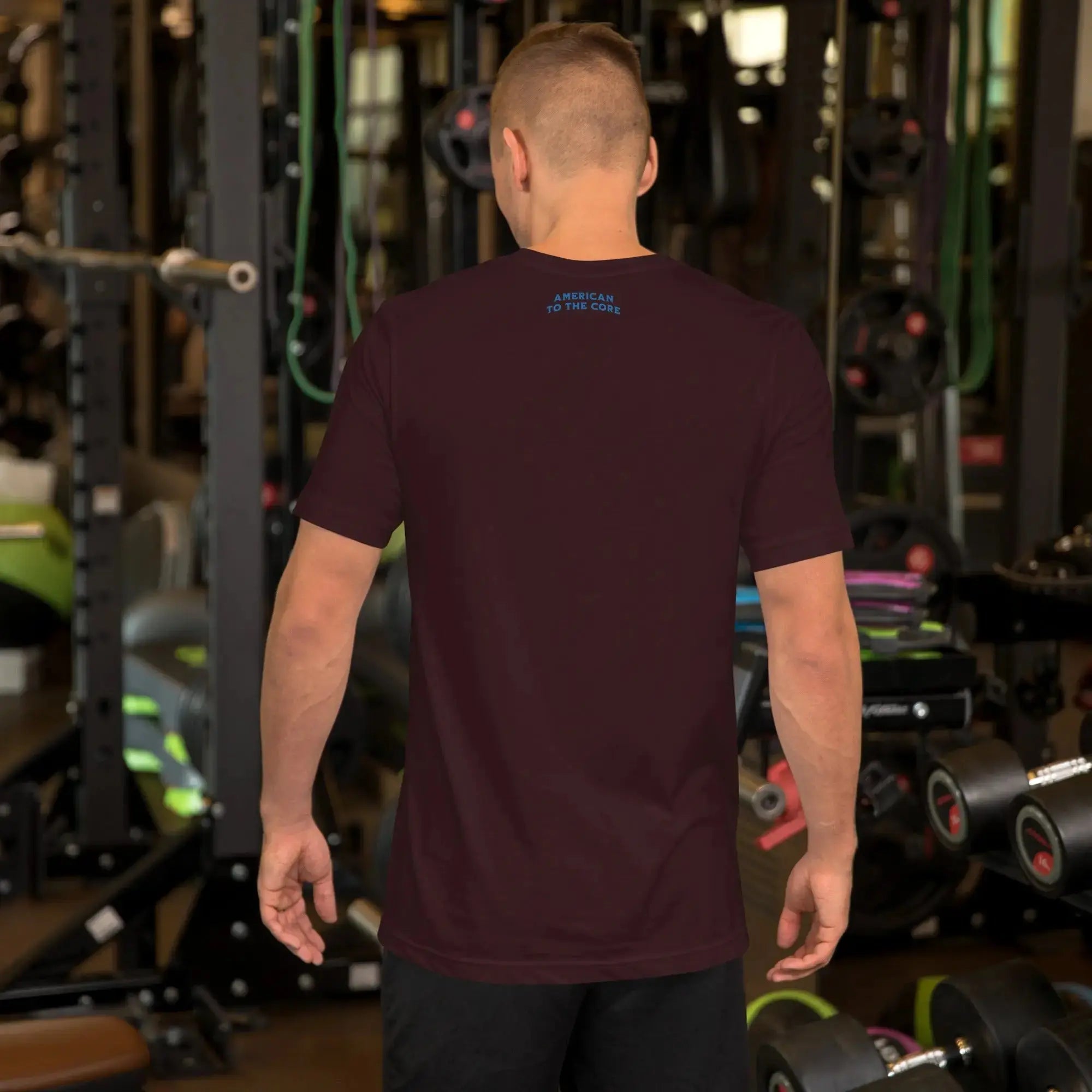 Back of a man wearing an oxblood black heather patriotic t-shirt with the text "American To The Core."