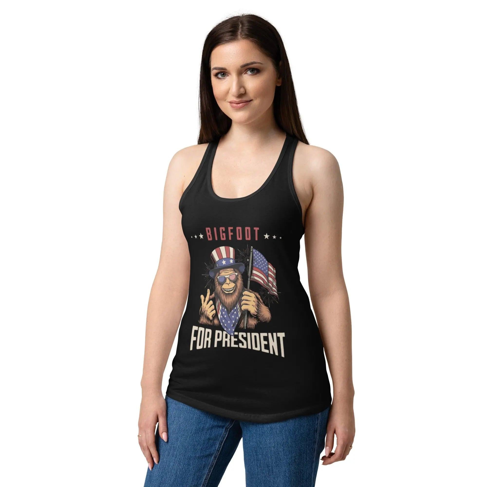 A woman wearing a black patriotic tank top with Bigfoot and the text "Bigfoot for president" 