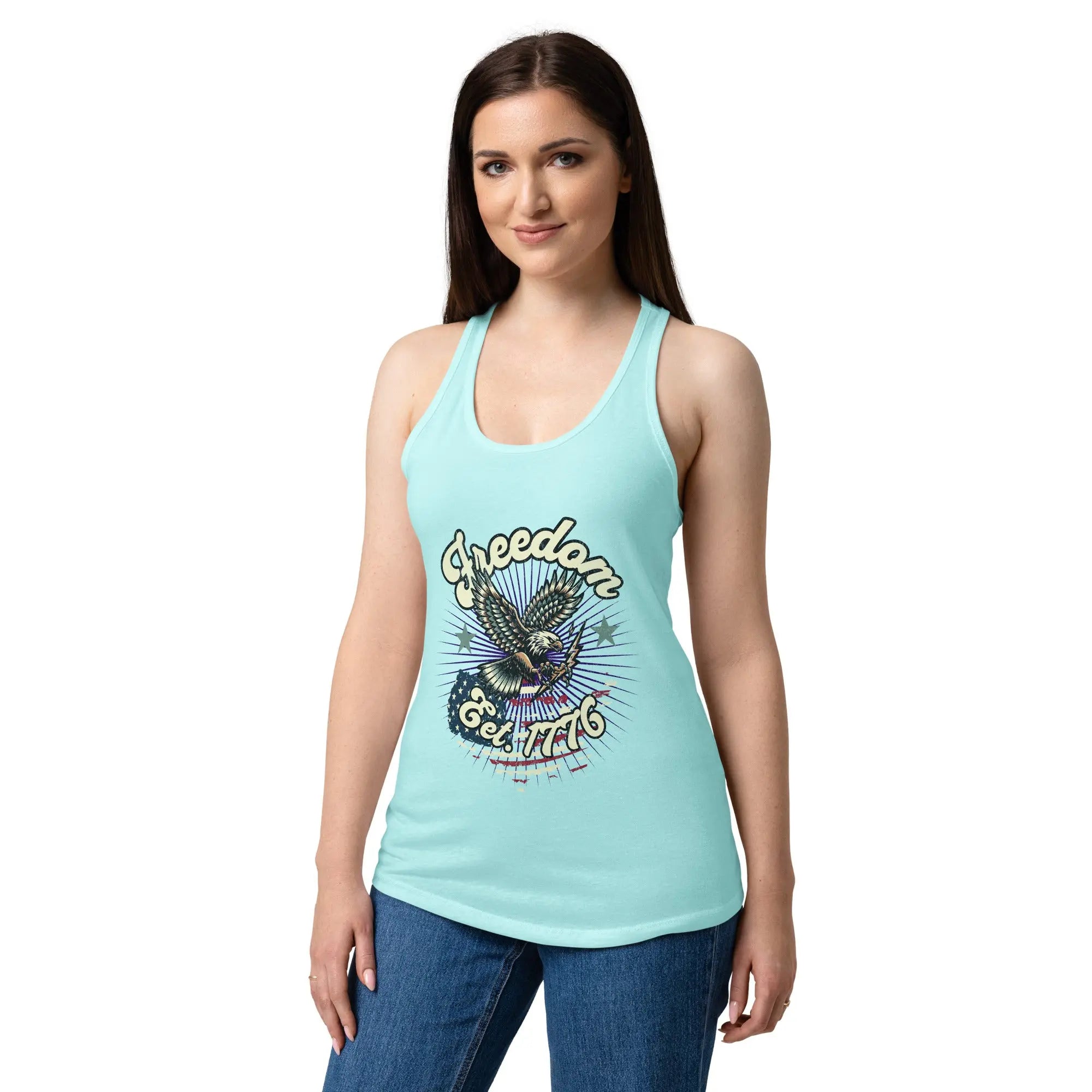 A woman wearing a cancun blue, fitted, patriotic racerback tank top with a flying eagle and the text "Freedom est. 1776."
