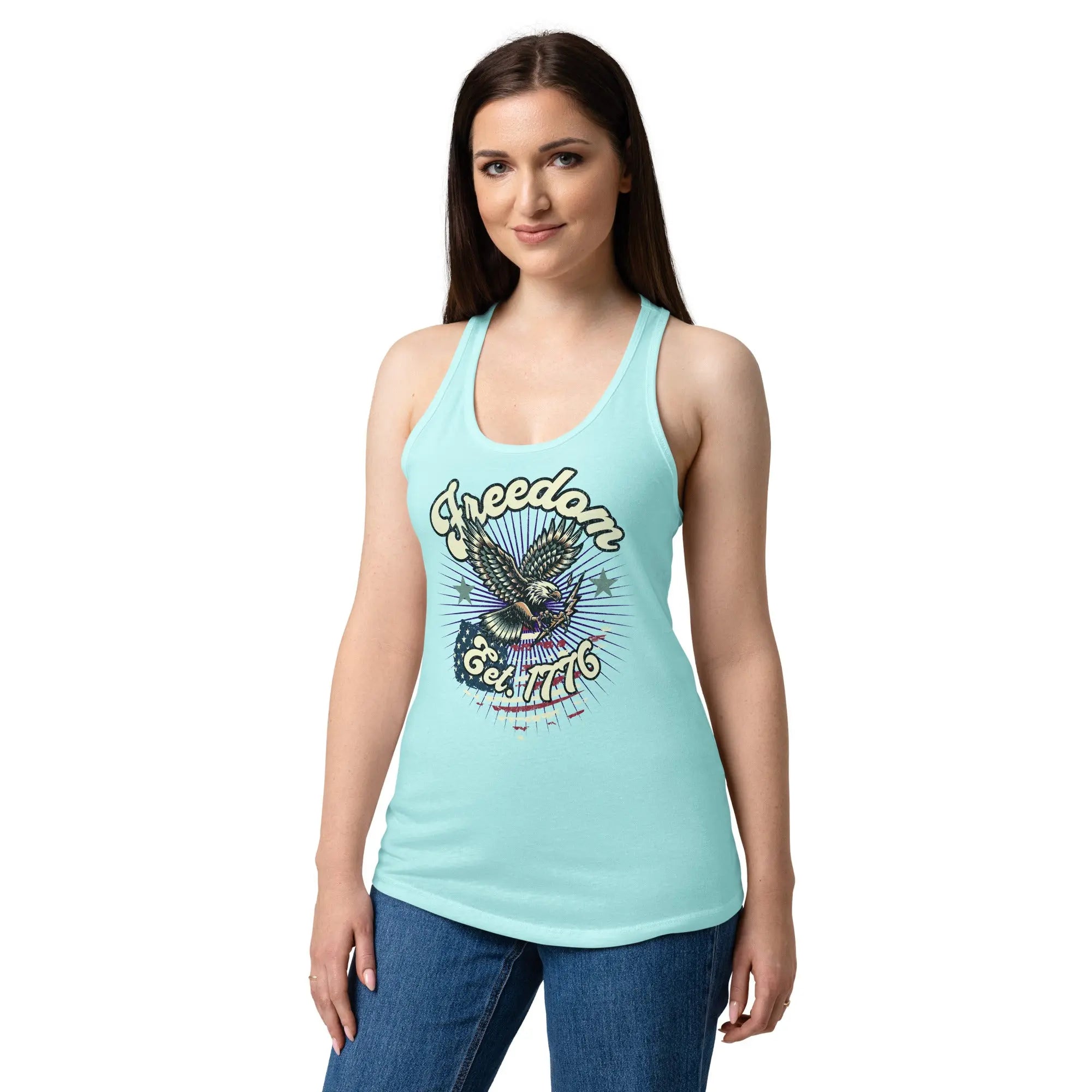 A woman wearing a cancun blue, fitted, patriotic racerback tank top with a flying eagle and the text "Freedom est. 1776."
