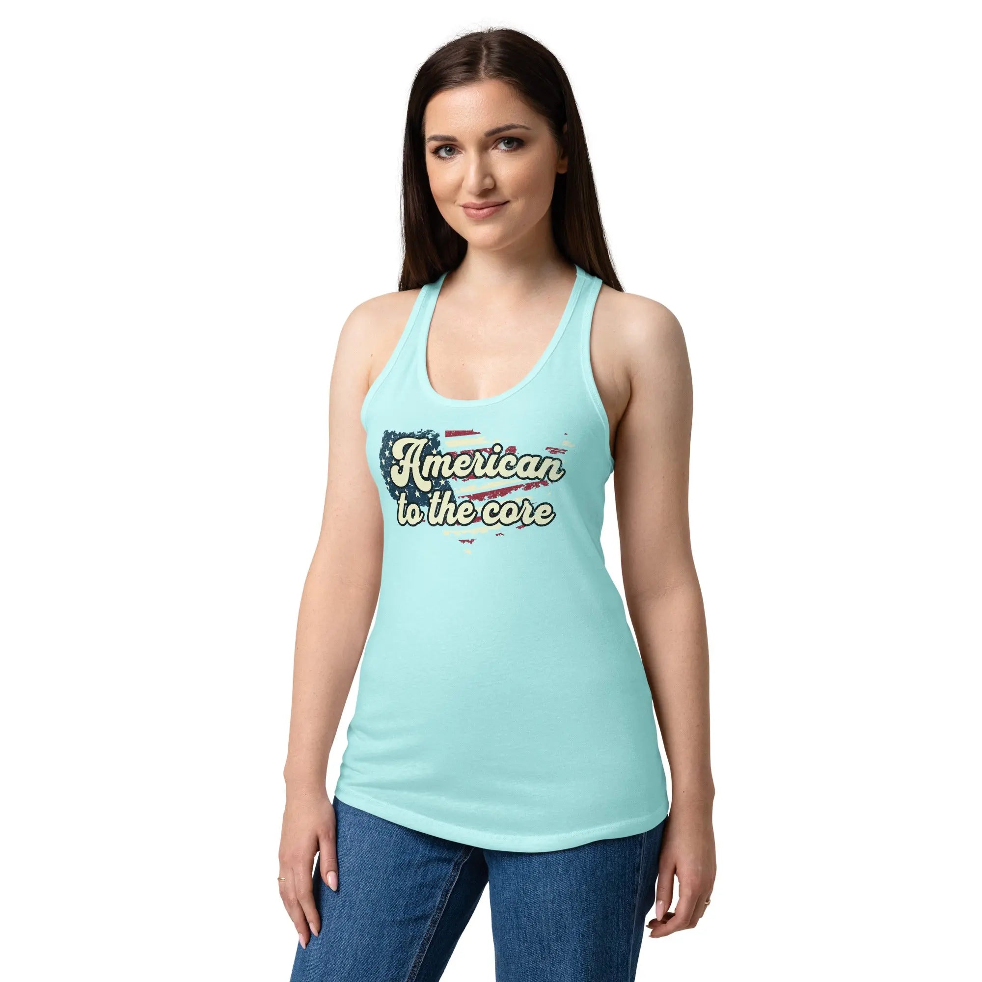A woman wearing a cancun blue, fitted, patriotic racerback tank top with an American flag shaped like the country and the text "American to the core."