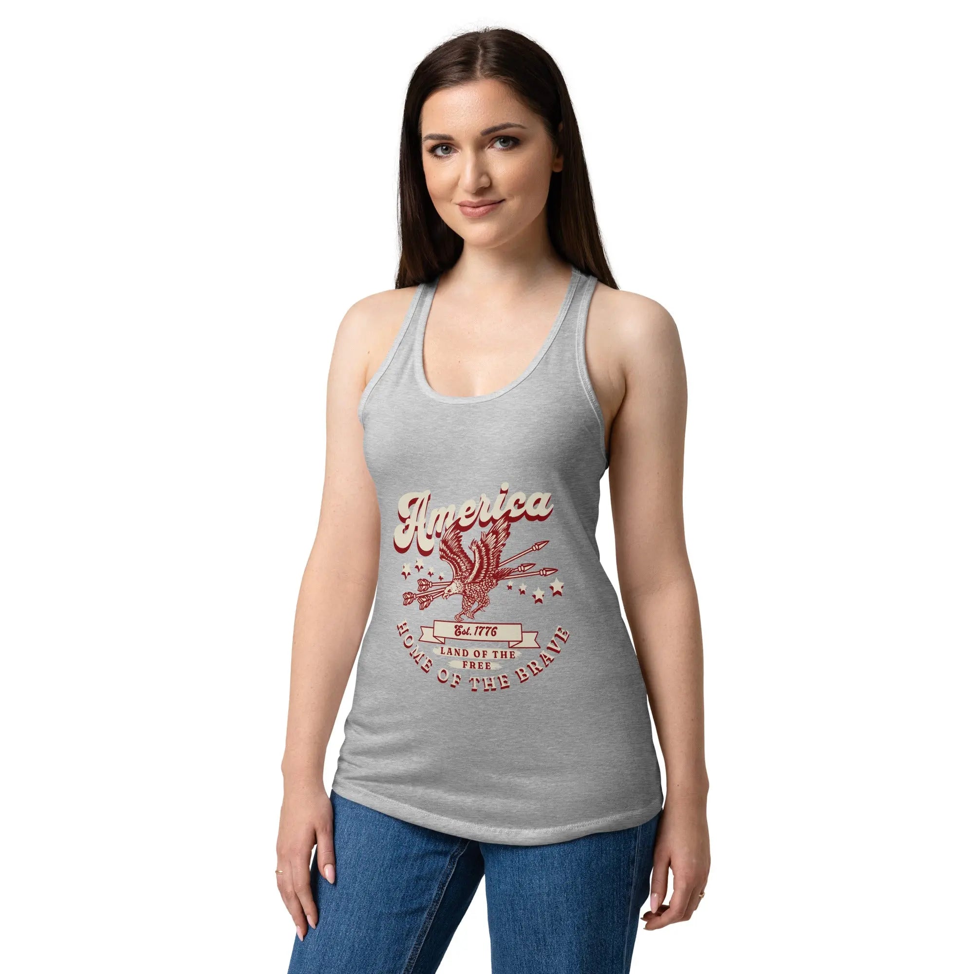 A woman wearing a heather grey patriotic tank top with a flying eagle and the text "America Home of the brave." 