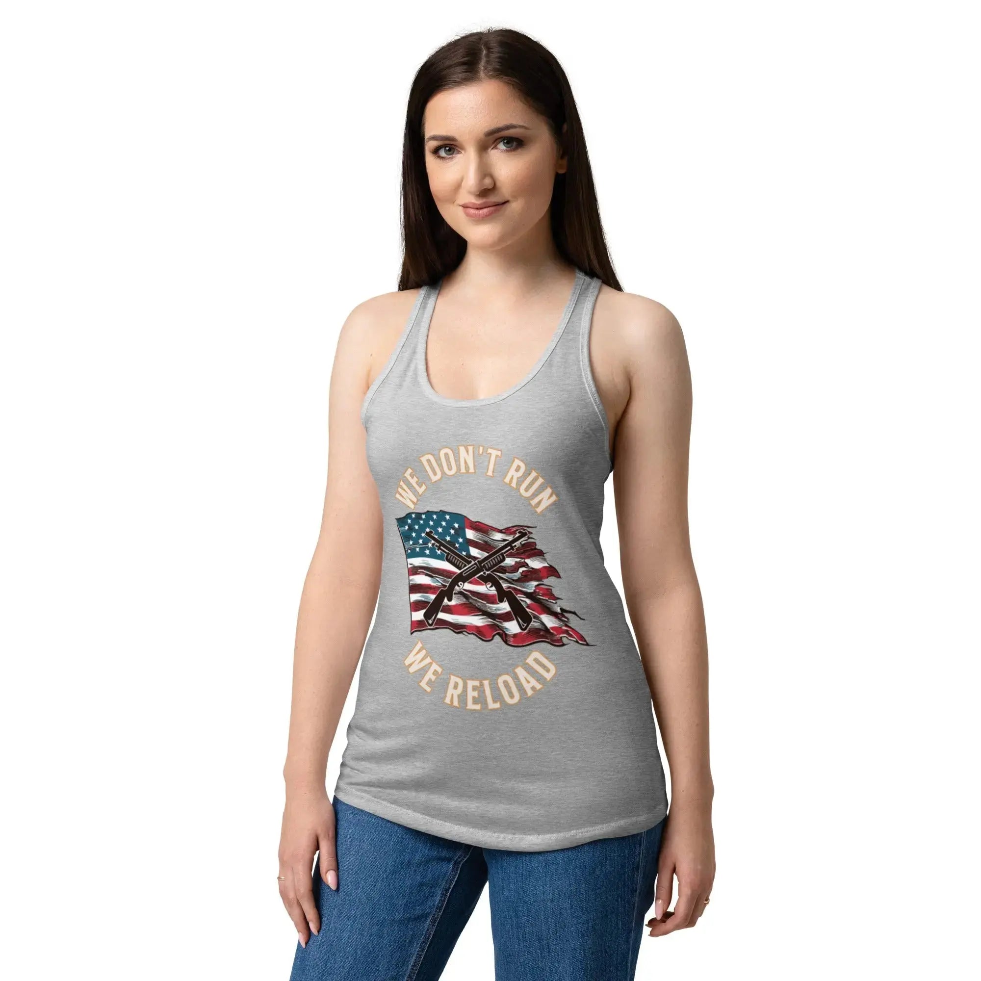 A woman wearing a heather grey patriotic tank top with shotguns over the flag and the text "We Don't Run, We Reload."