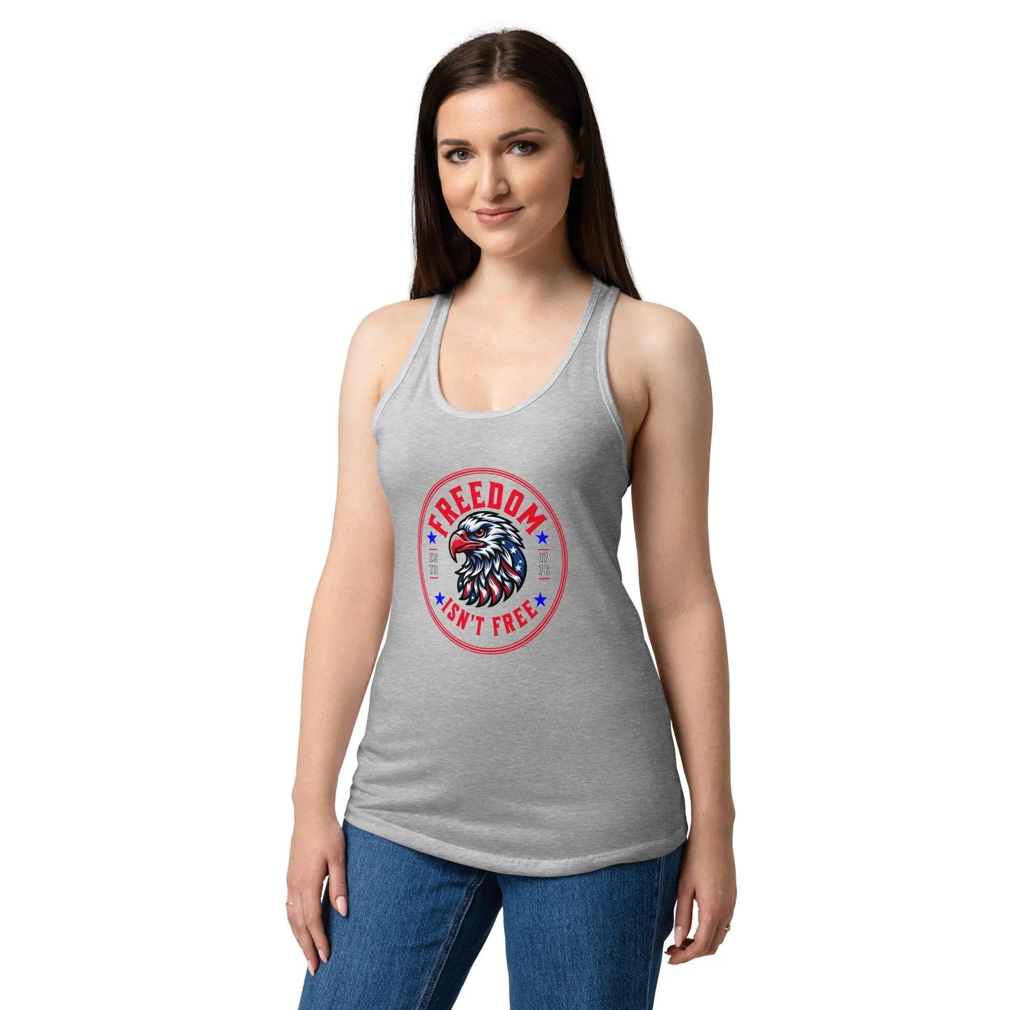 A woman wearing a heather grey patriotic tank top with an eagle head and the text "Freedom isn't free." 