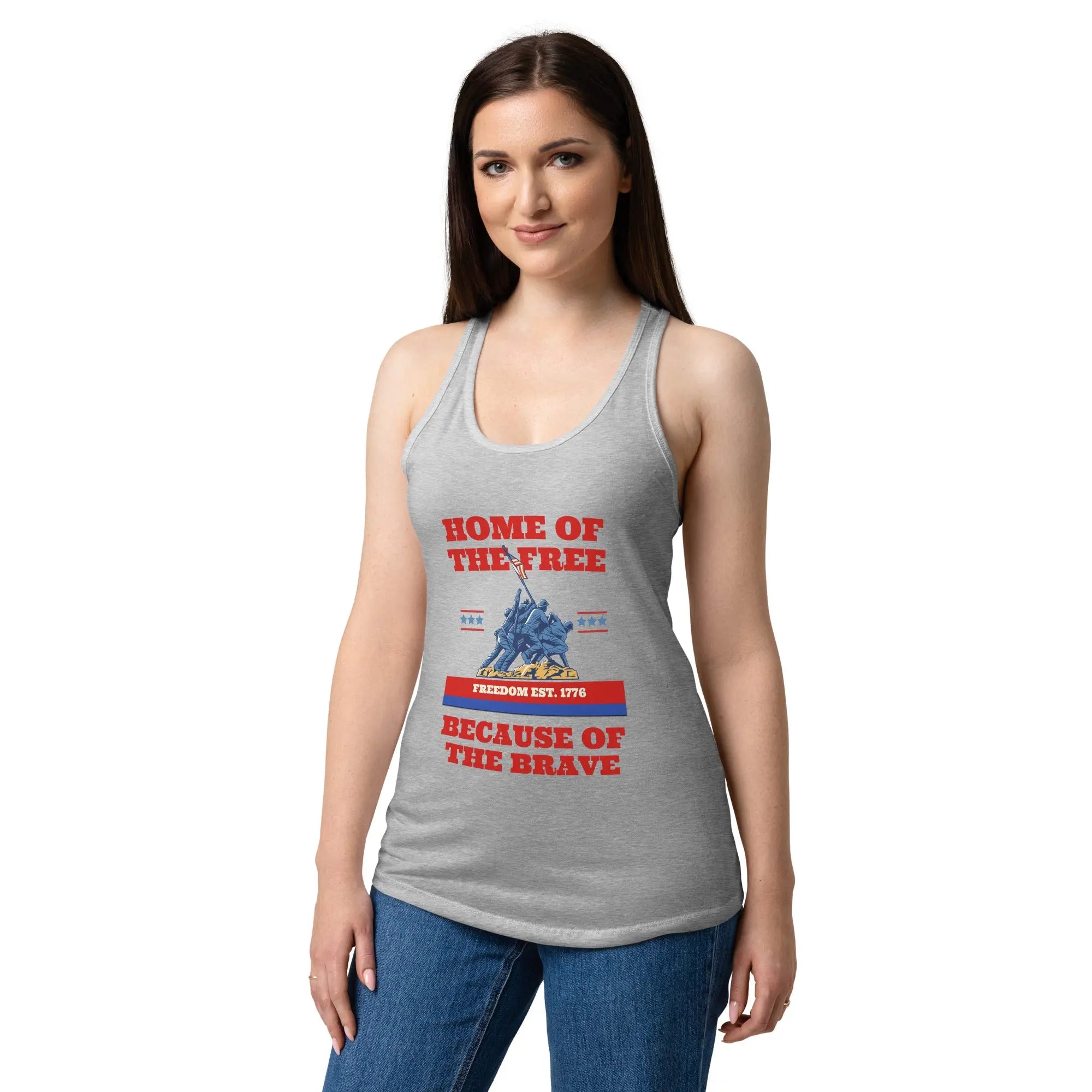 A woman wearing a heather grey patriotic tank top with soldiers raising the flag and the text "Home of the free because of the brave."