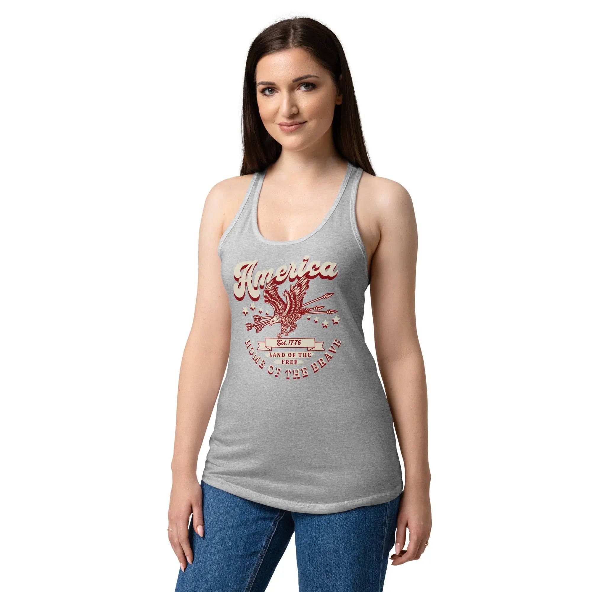 A woman wearing a heather gray patriotic tank top with a flying eagle and the text "America Home of the brave." 