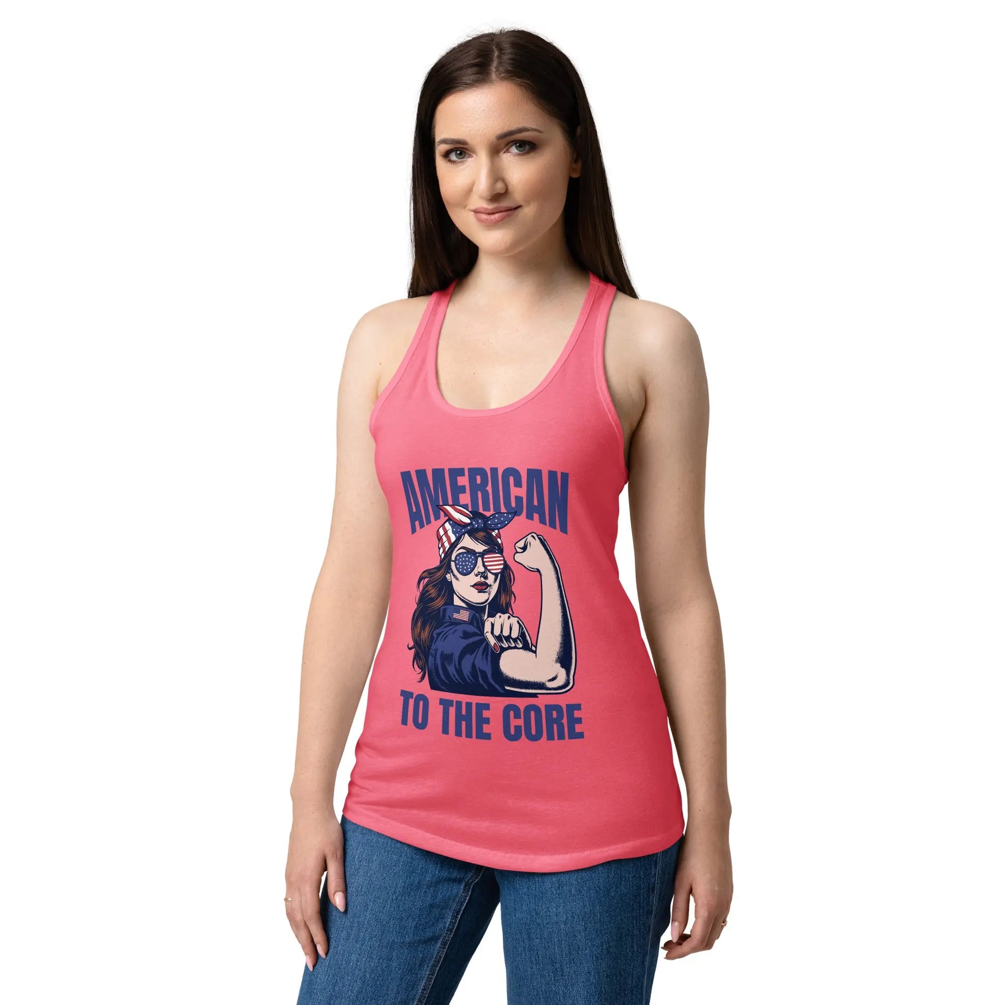 A woman wearing a hot pink, fitted, patriotic racerback tank top with a woman flexing and the text "American to the core."