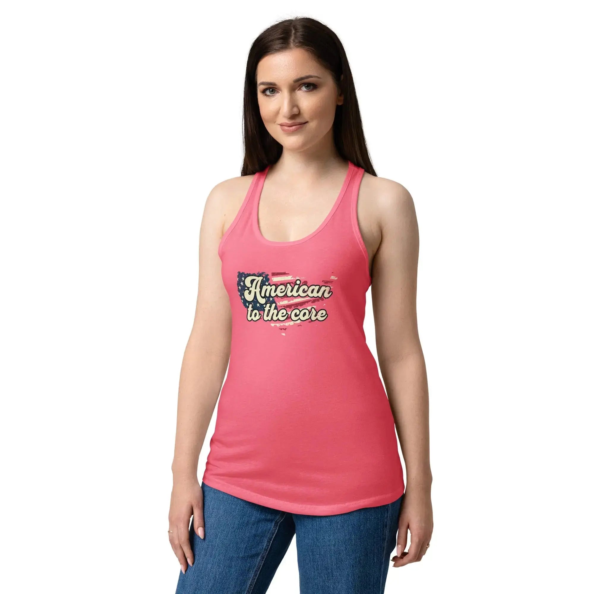 A woman wearing a hot pink, fitted, patriotic racerback tank top with an American flag shaped like the country and the text "American to the core."
