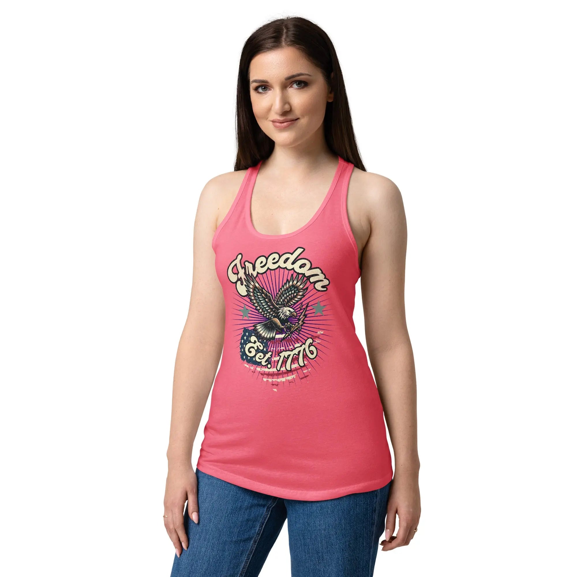 A woman wearing a hot pink, fitted, patriotic racerback tank top with a flying eagle and the text "Freedom est. 1776."