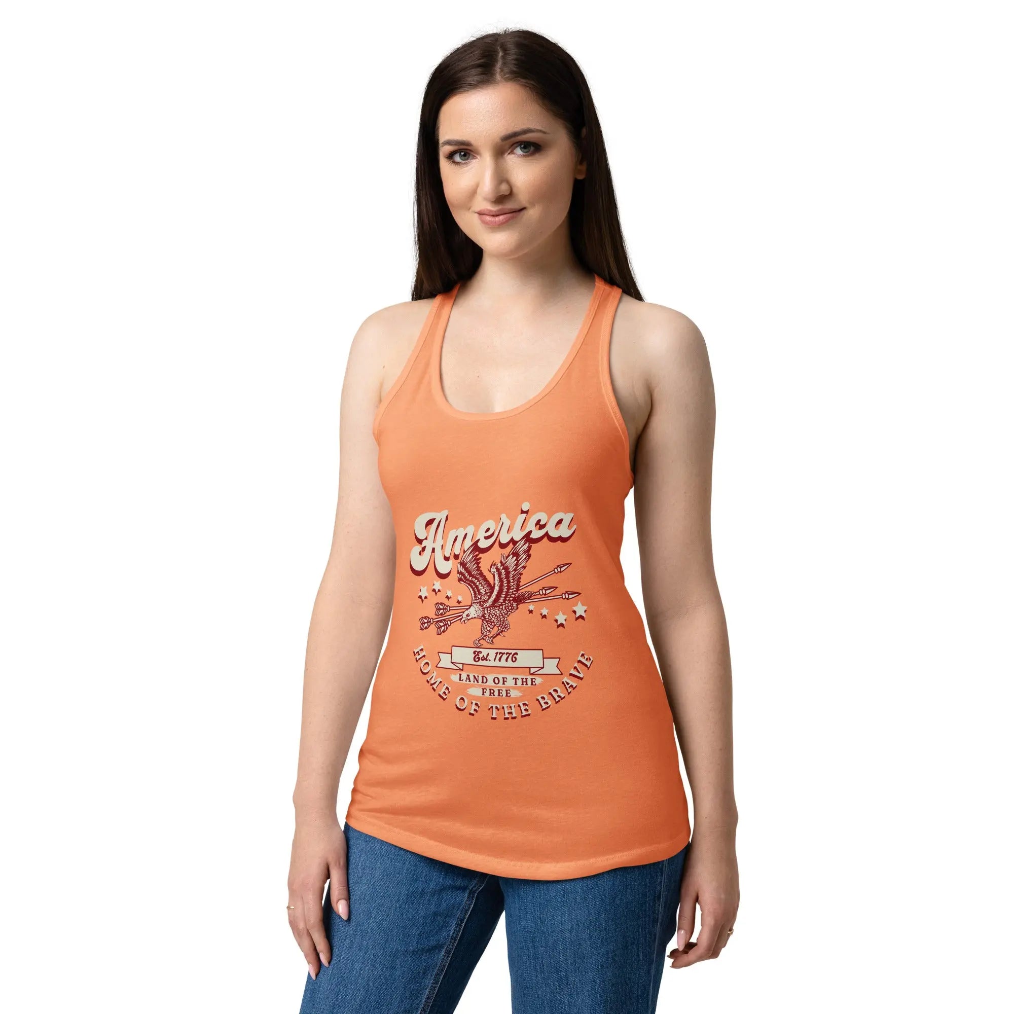 A woman wearing a light orange patriotic tank top with a flying eagle and the text "America Home of the brave." 