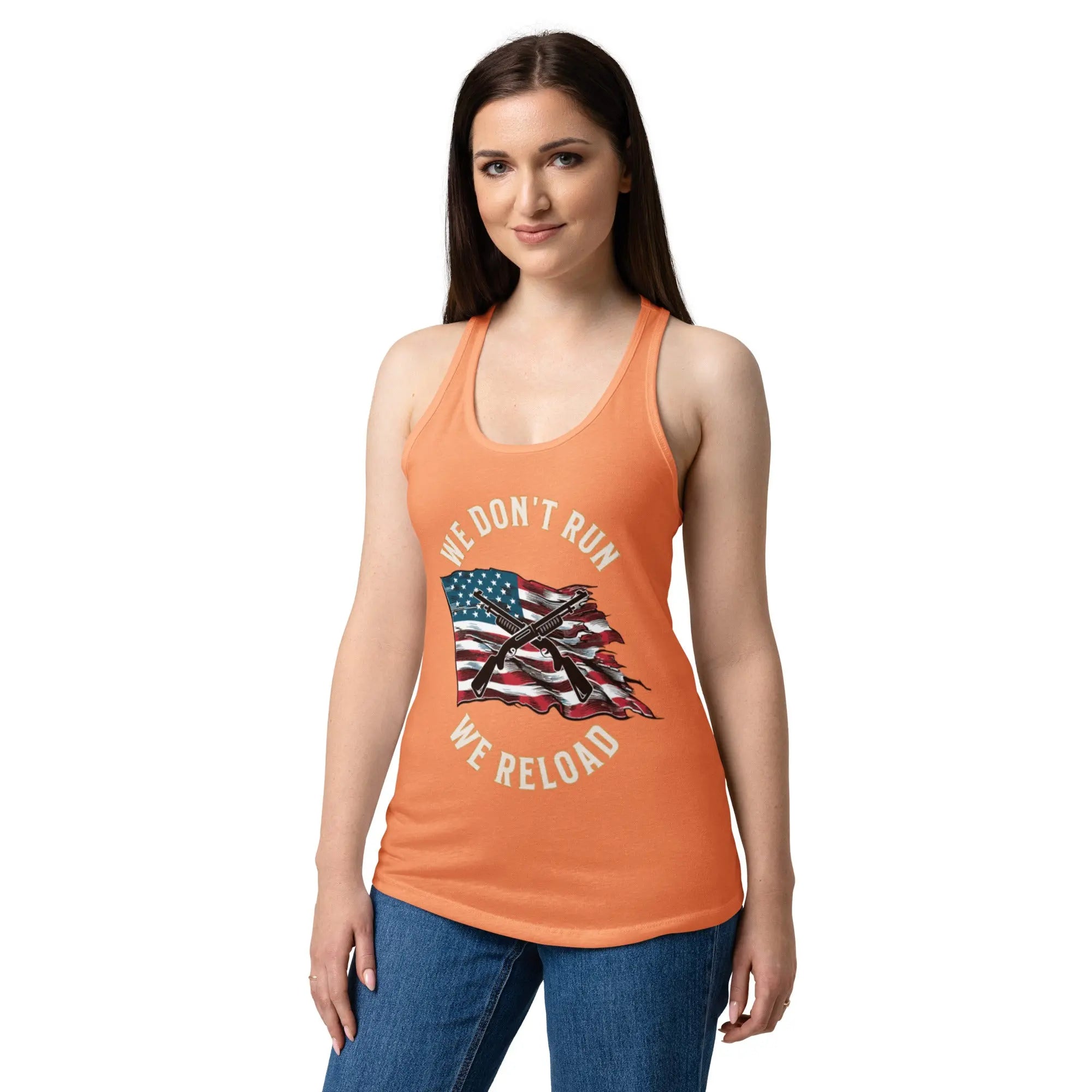 A woman wearing a light orange patriotic tank top with shotguns over the flag and the text "We Don't Run, We Reload."