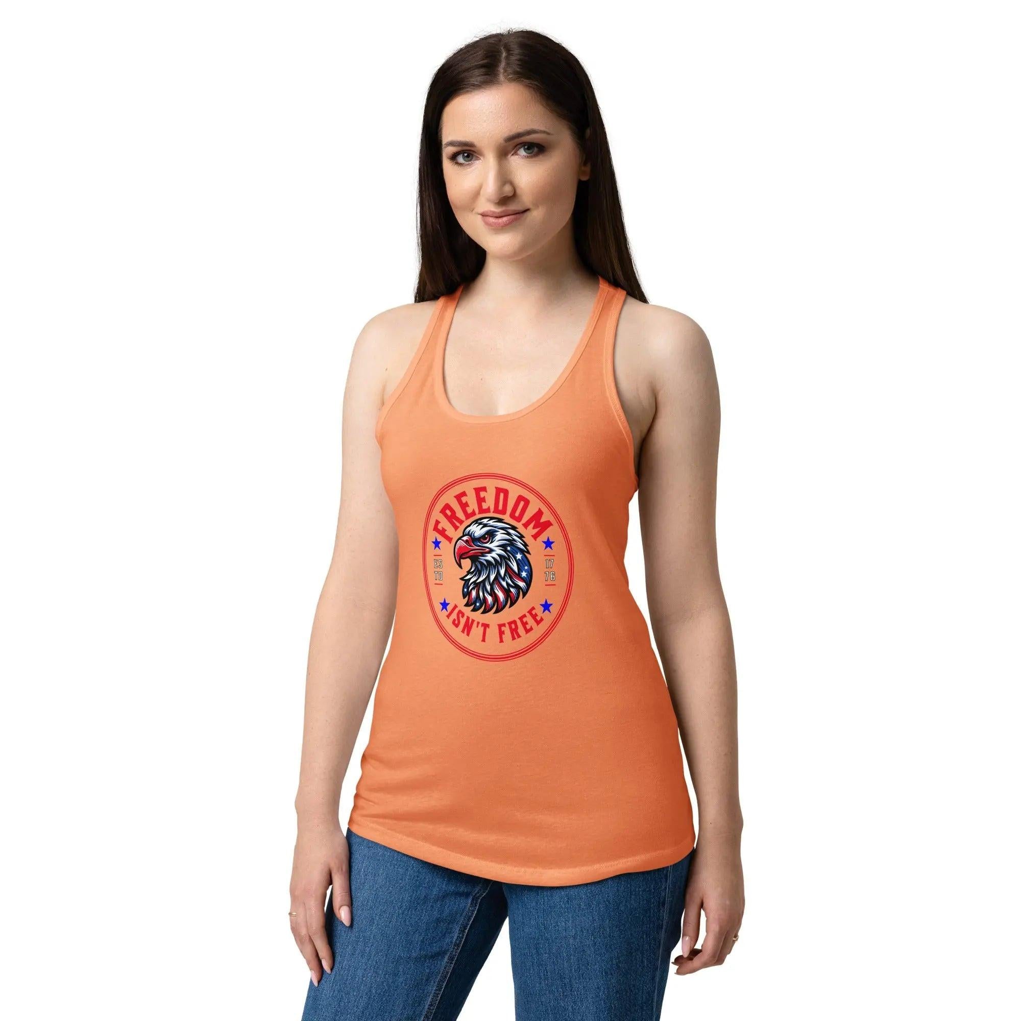 A woman wearing a light orange patriotic tank top with an eagle head and the text "Freedom isn't free" 