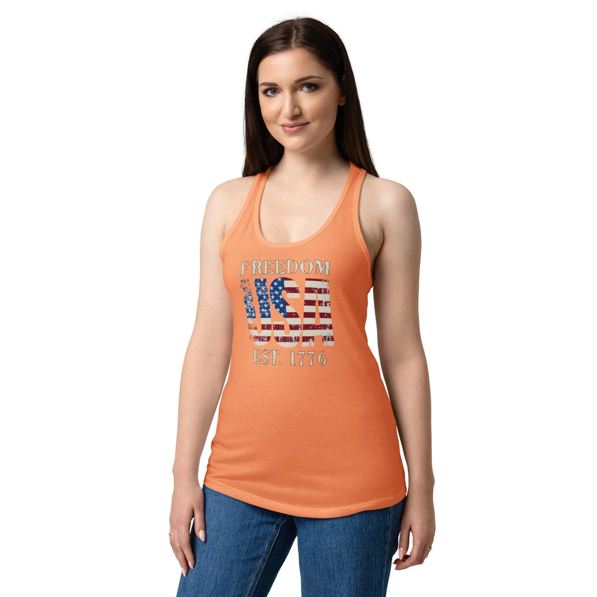 A woman wearing a light orange patriotic tank top with the american flag in the shape of USA and the text "Freedom set. 1776"