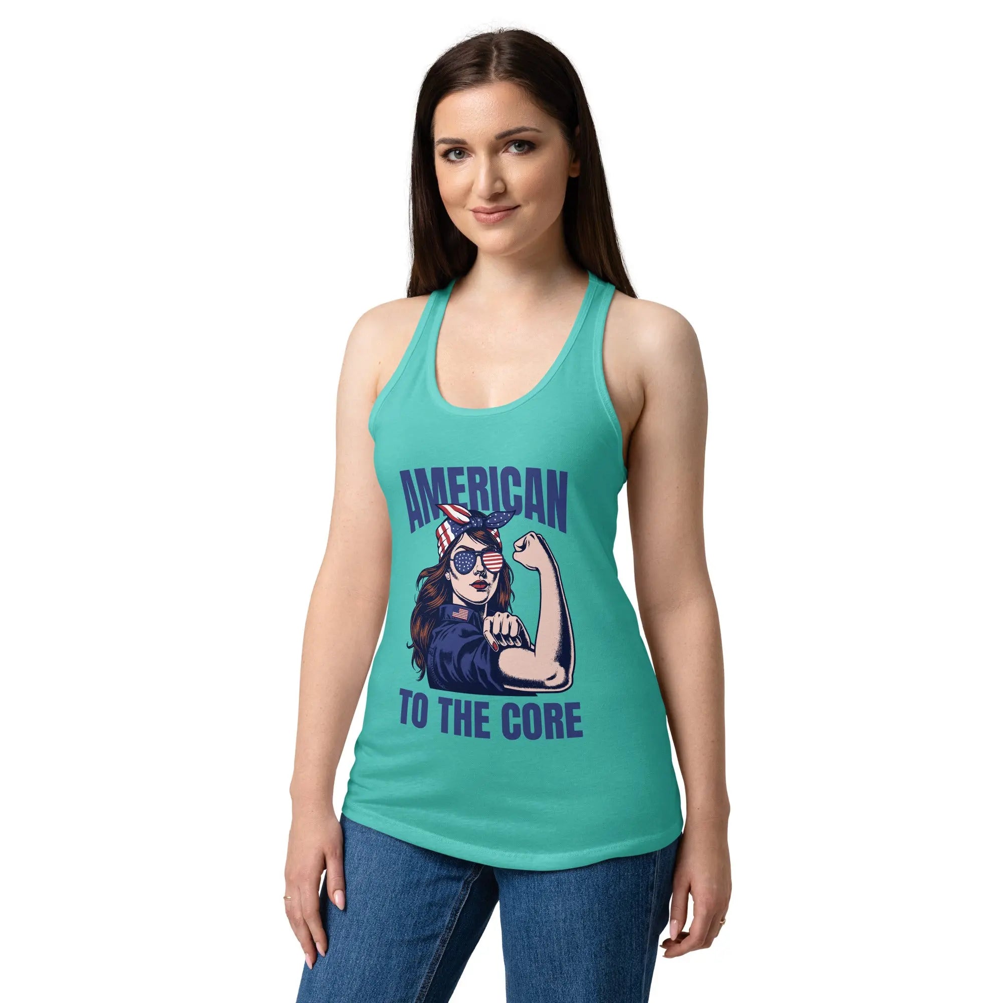 A woman wearing a tahiti blue, fitted, patriotic racerback tank top with a woman flexing and the text "American to the core."
