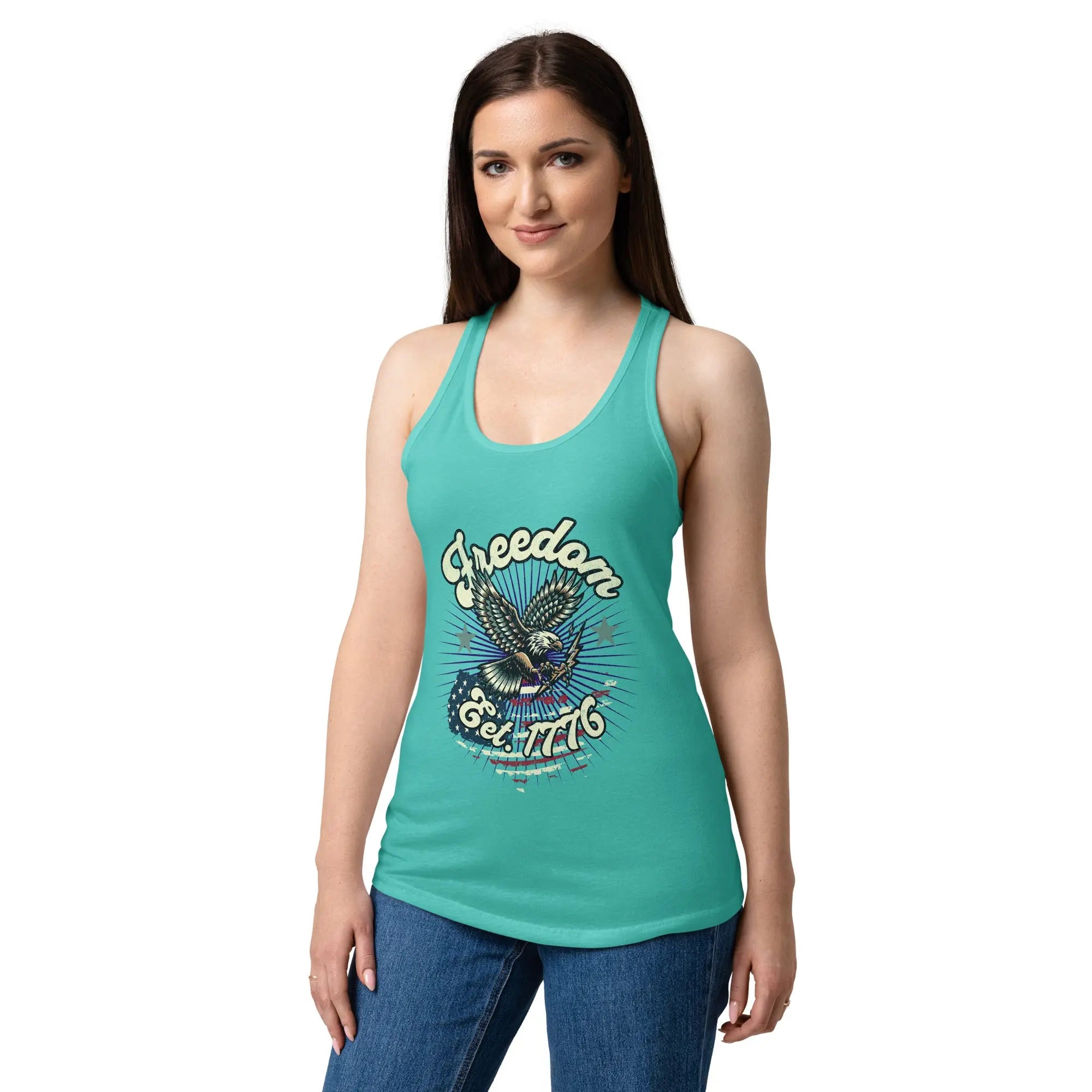 A woman wearing a tahiti blue, fitted, patriotic racerback tank top with a flying eagle and the text "Freedom est. 1776."