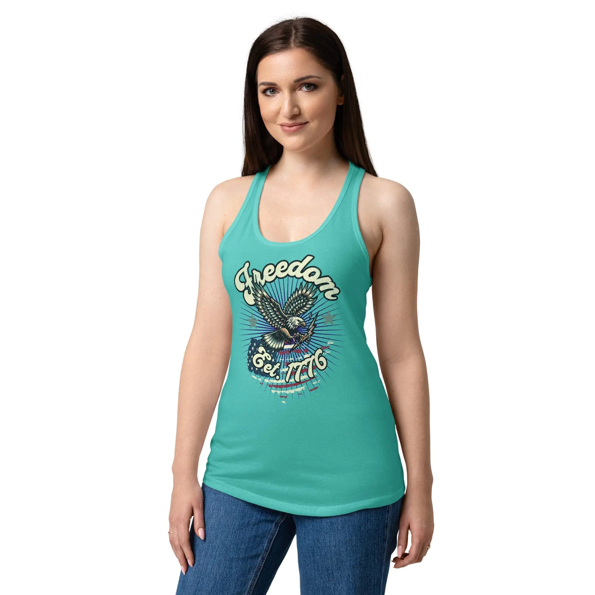 A woman wearing a tahiti blue, fitted, patriotic racerback tank top with a flying eagle and the text "Freedom est. 1776."