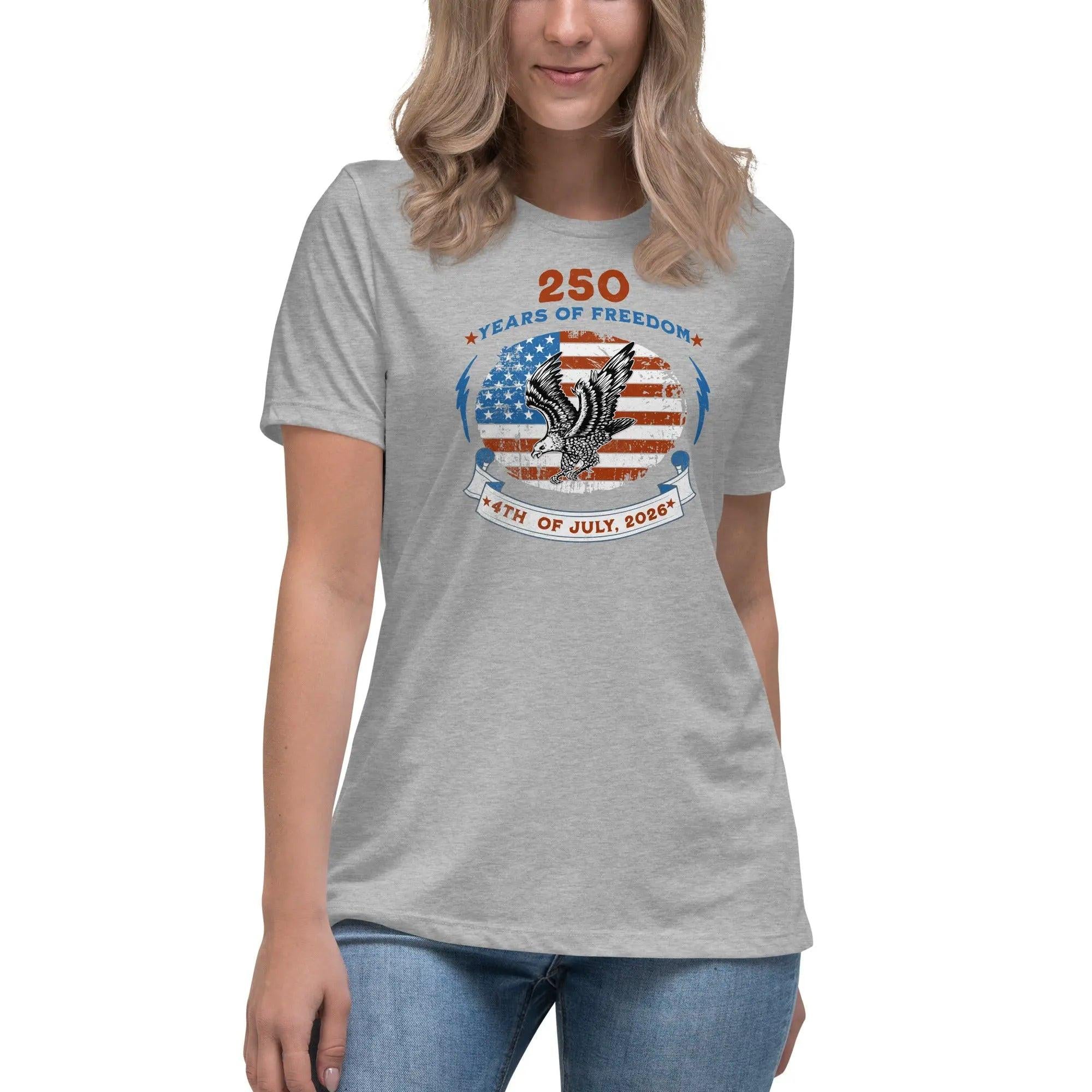 A woman wearing a athletic heather patriotic t-shirt with the American flag with a flying eagle over it and the text "250 years of freedom 4th of July, 2026."