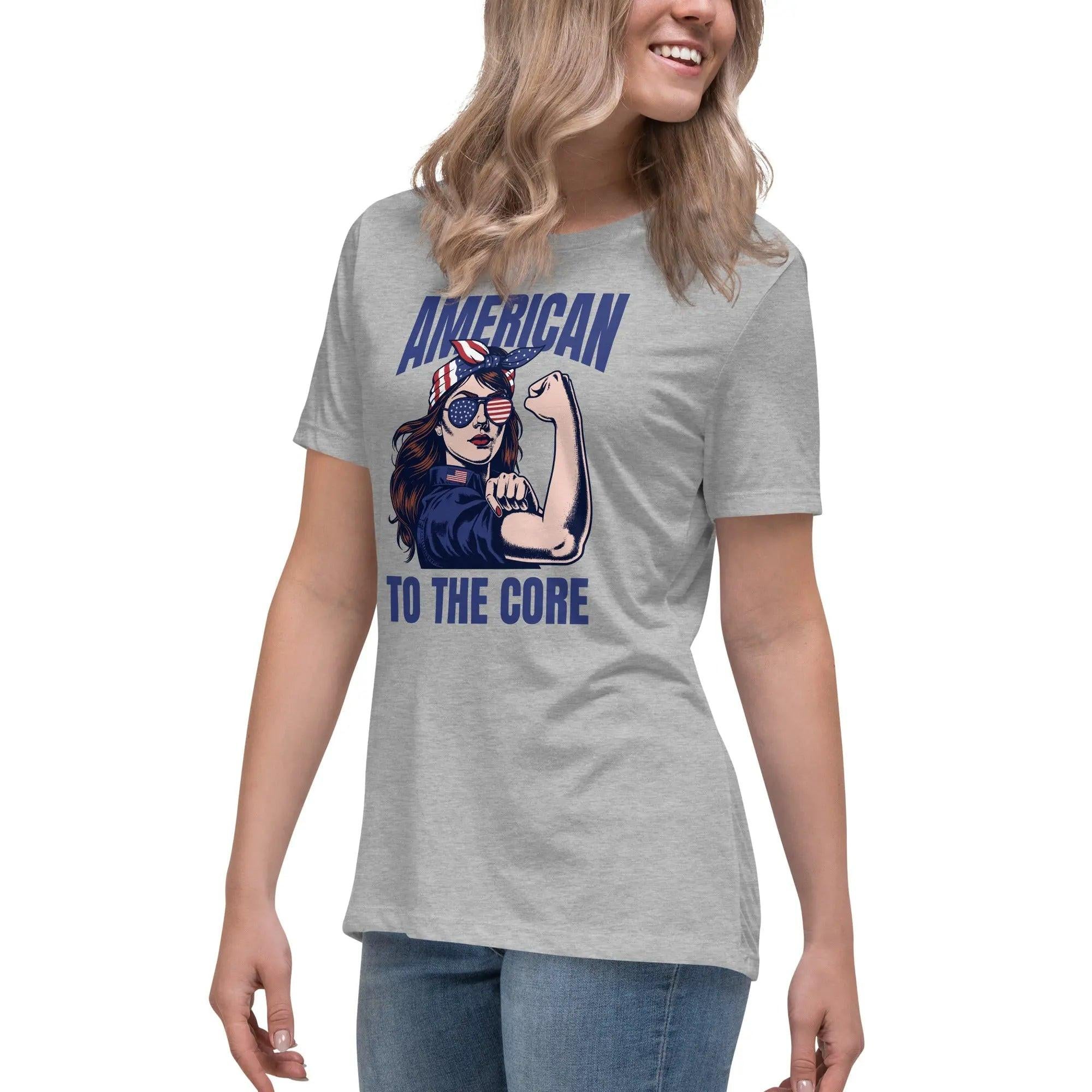 A woman wearing an athletic heather, patriotic t-shirt with a strong woman and "American To The Core" text.
