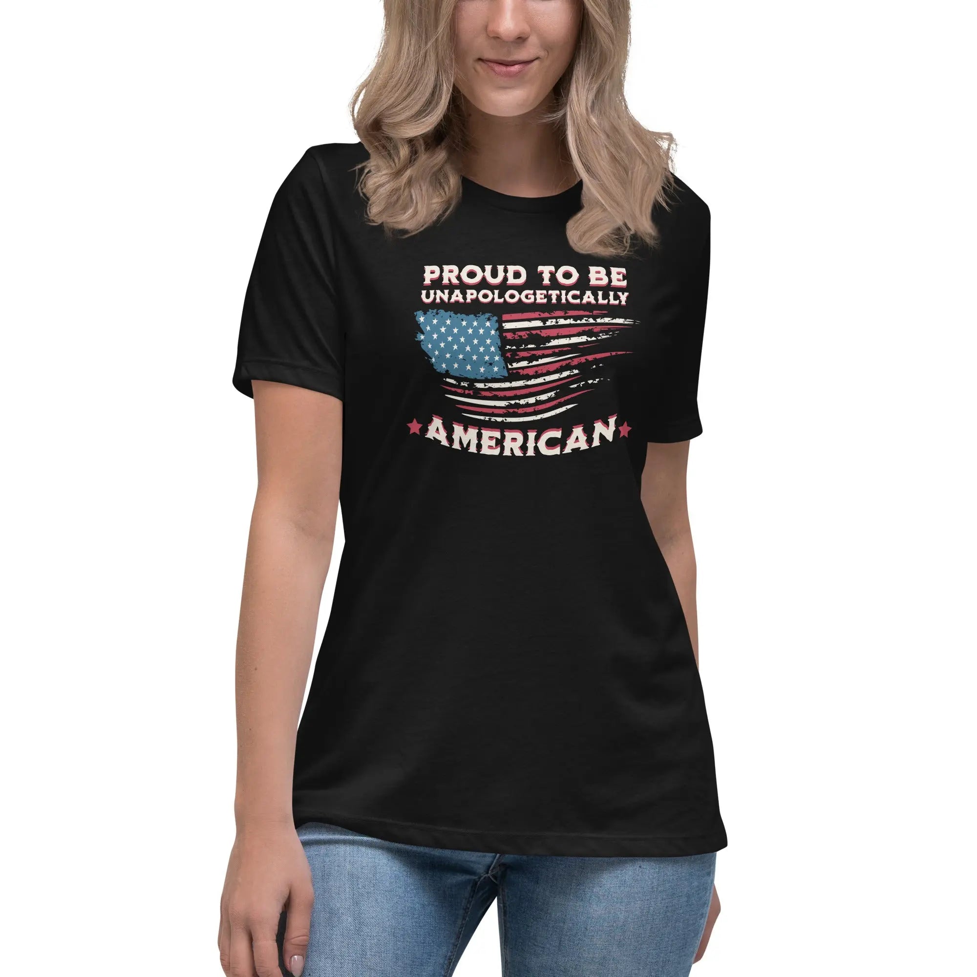 A woman wearing a black patriotic t-shirt with the American flag and "Proud To Be Unapologetically American" text.