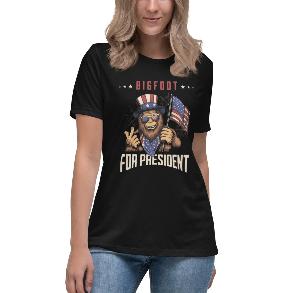 A woman wearing a Black patriotic t-shirt with Bigfoot and "Bigfoot For President" text.