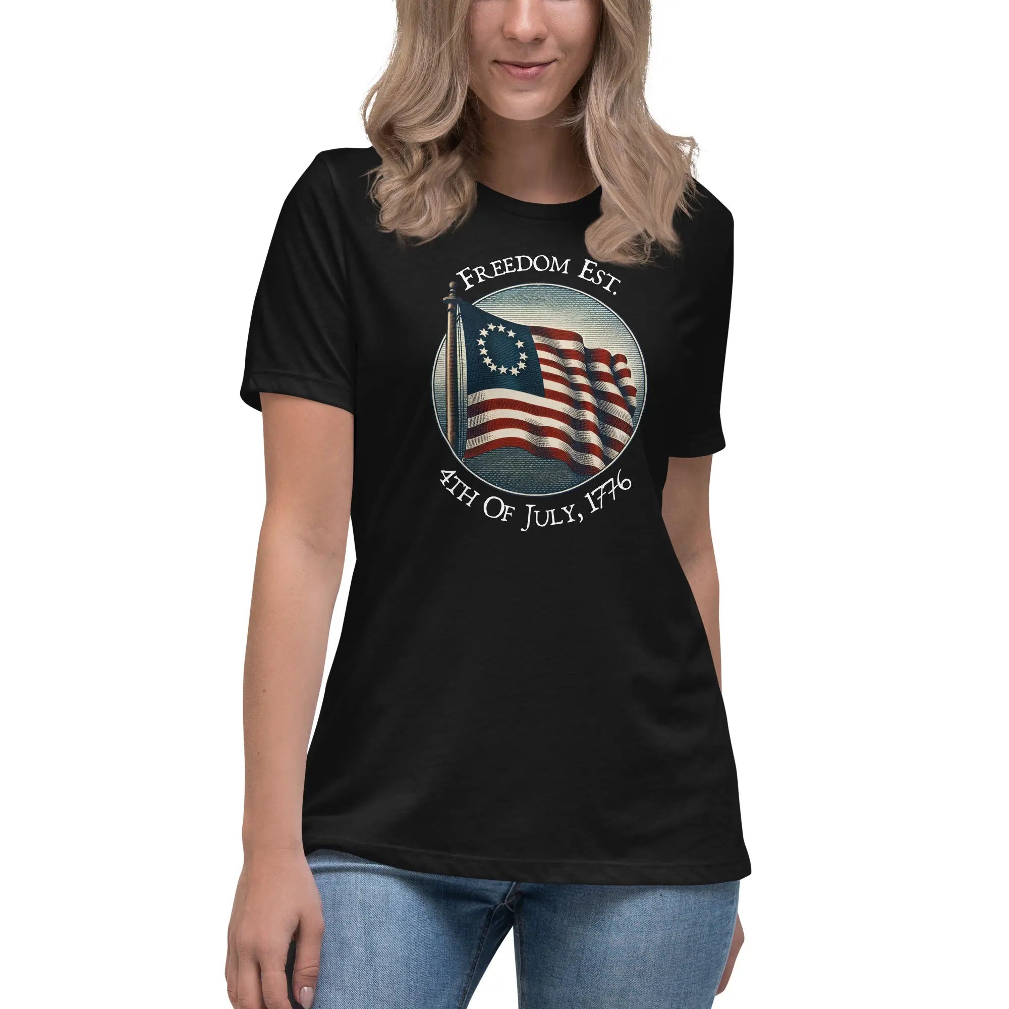 A woman wearing a black patriotic t-shirt with the American flag and the text "Freedom est. 4th of July, 1776."