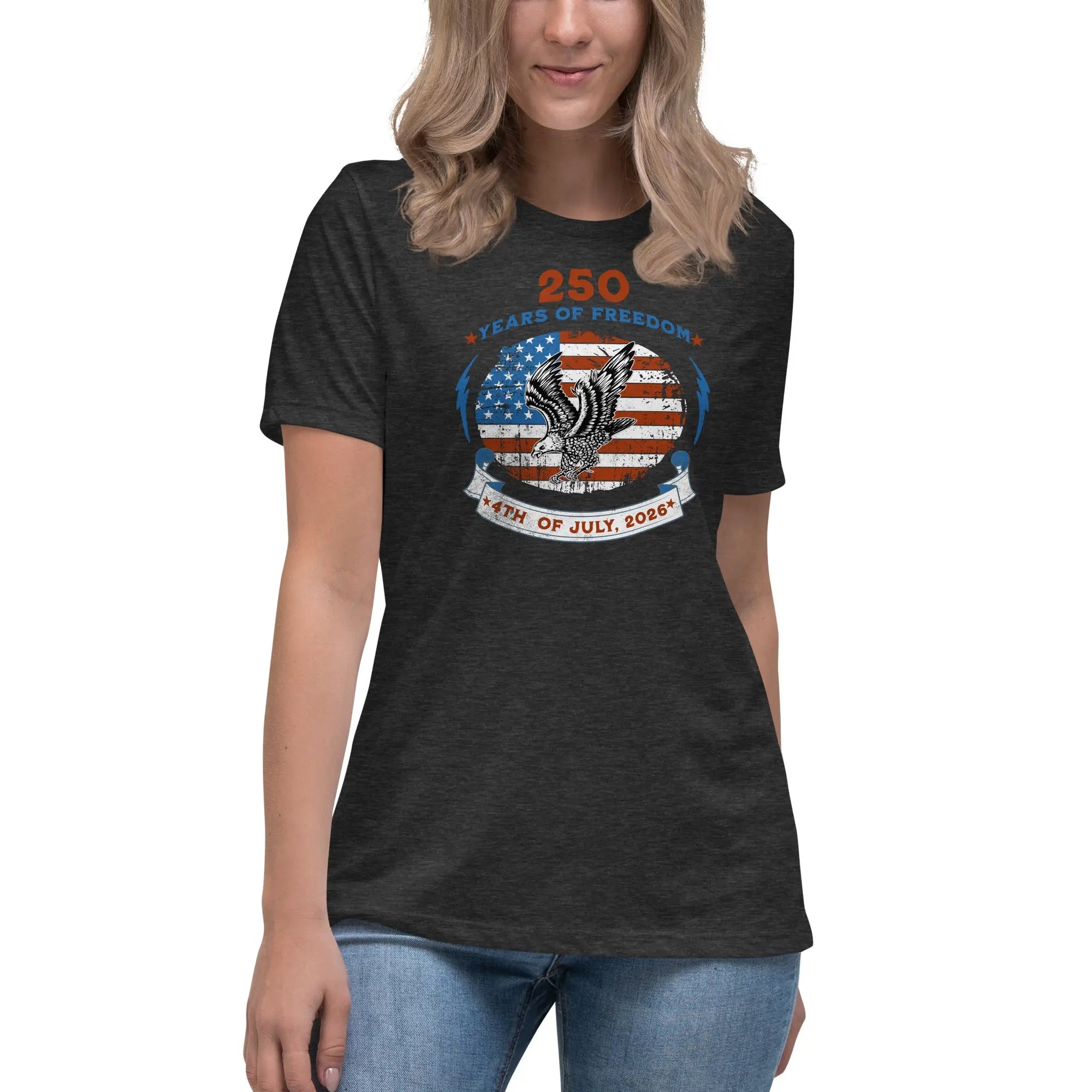 A woman wearing a dark grey heather patriotic t-shirt with the American flag with a flying eagle over it and the text "250 years of freedom 4th of July, 2026."