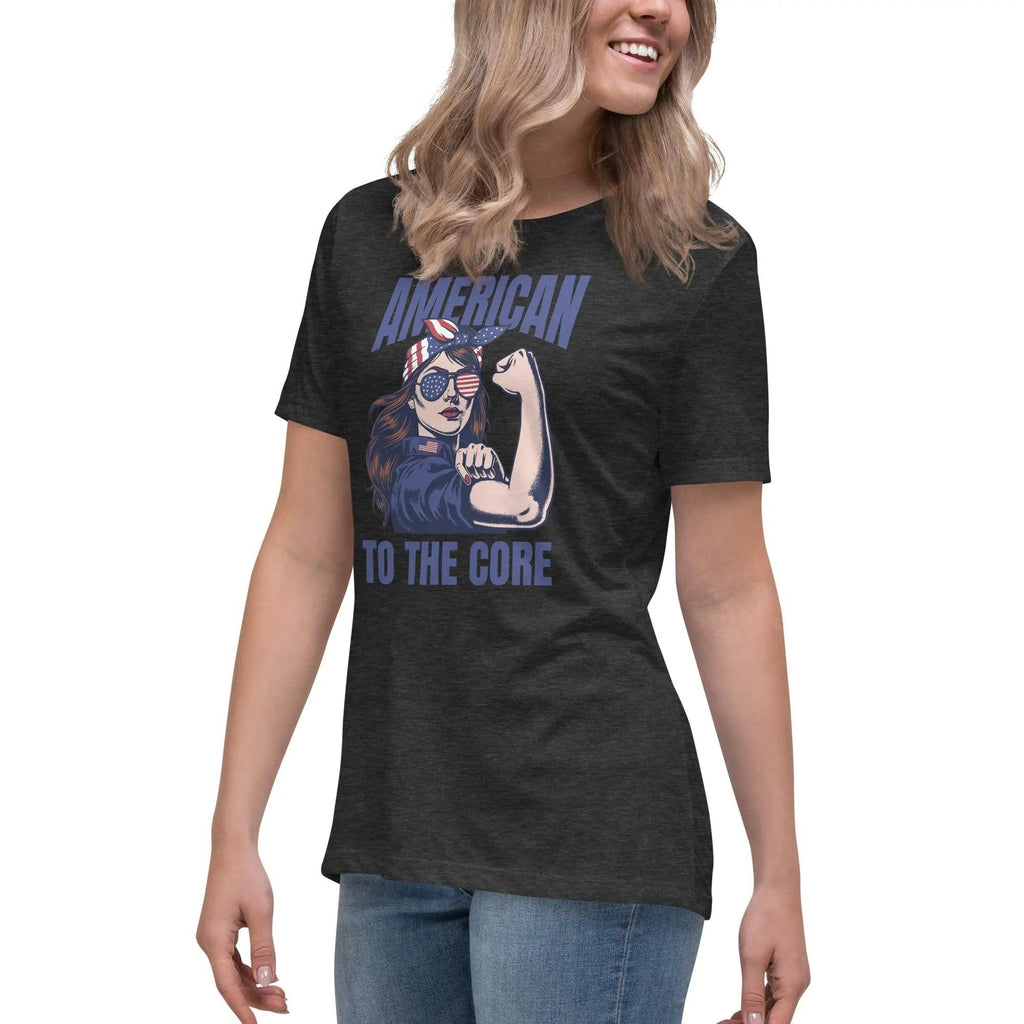 A woman wearing a dark grey, patriotic t-shirt with a strong woman and "American To The Core" text.