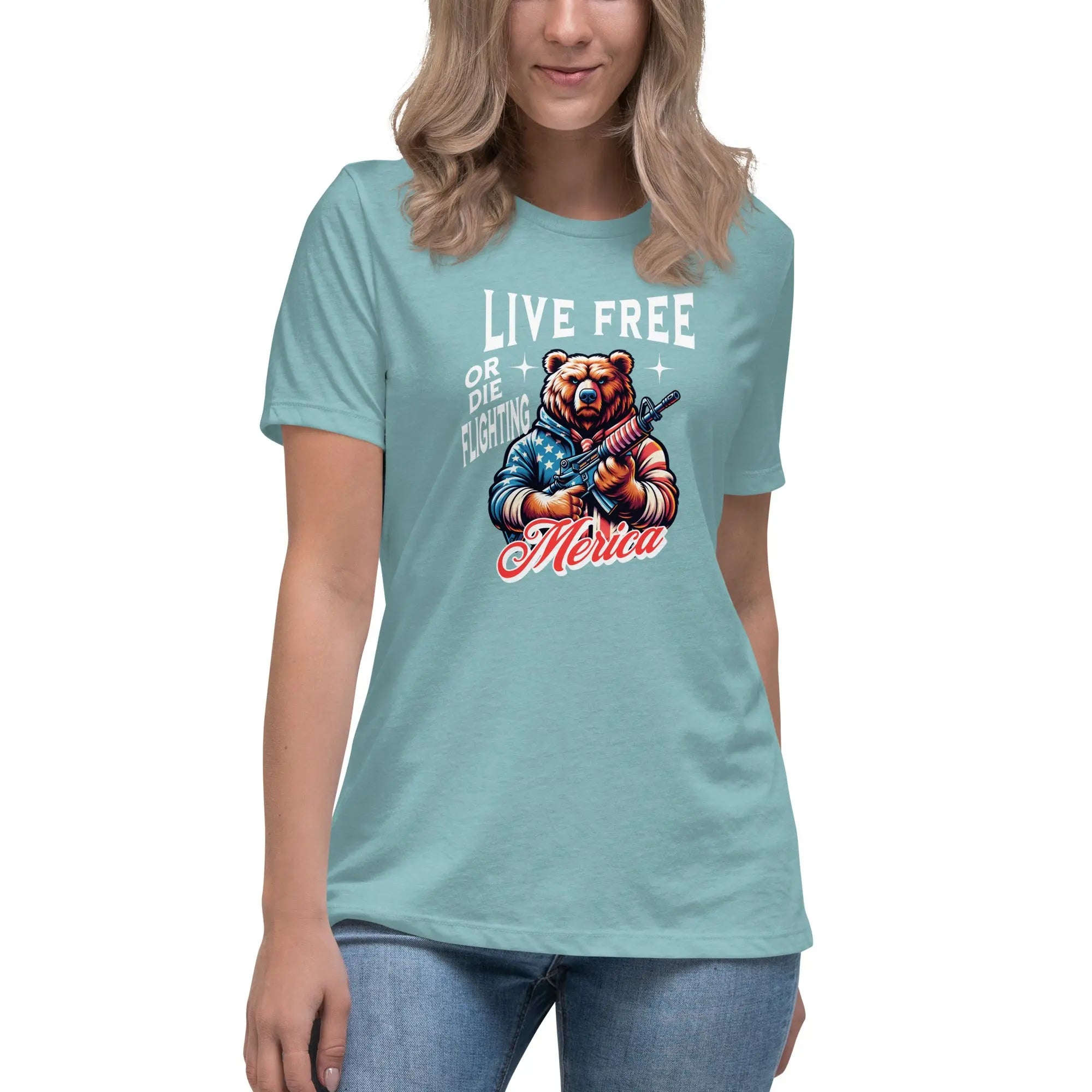 A woman wearing a heather blue lagoon patriotic t-shirt with a bear holding a gun and "Live Free or Die Fighting" text.