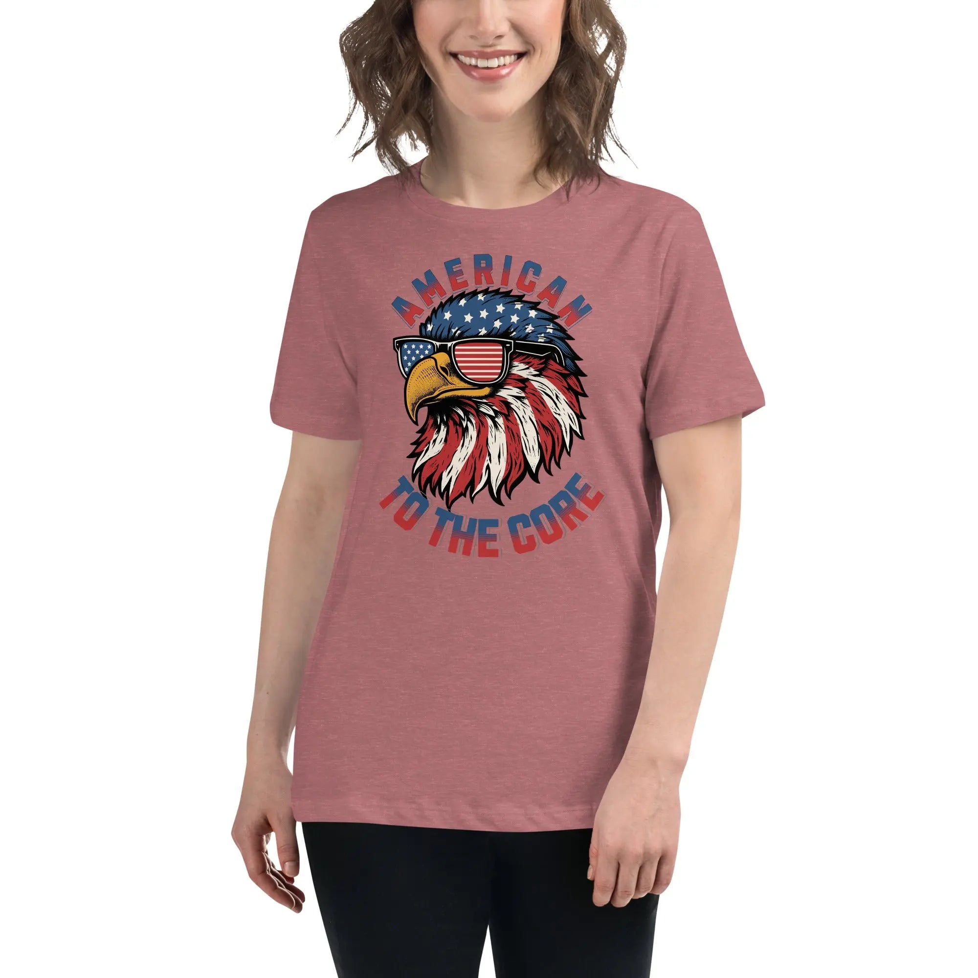 Back of woman wearing a heather mauve patriotic t-shirt with an eagle head and  "American To The Core" text